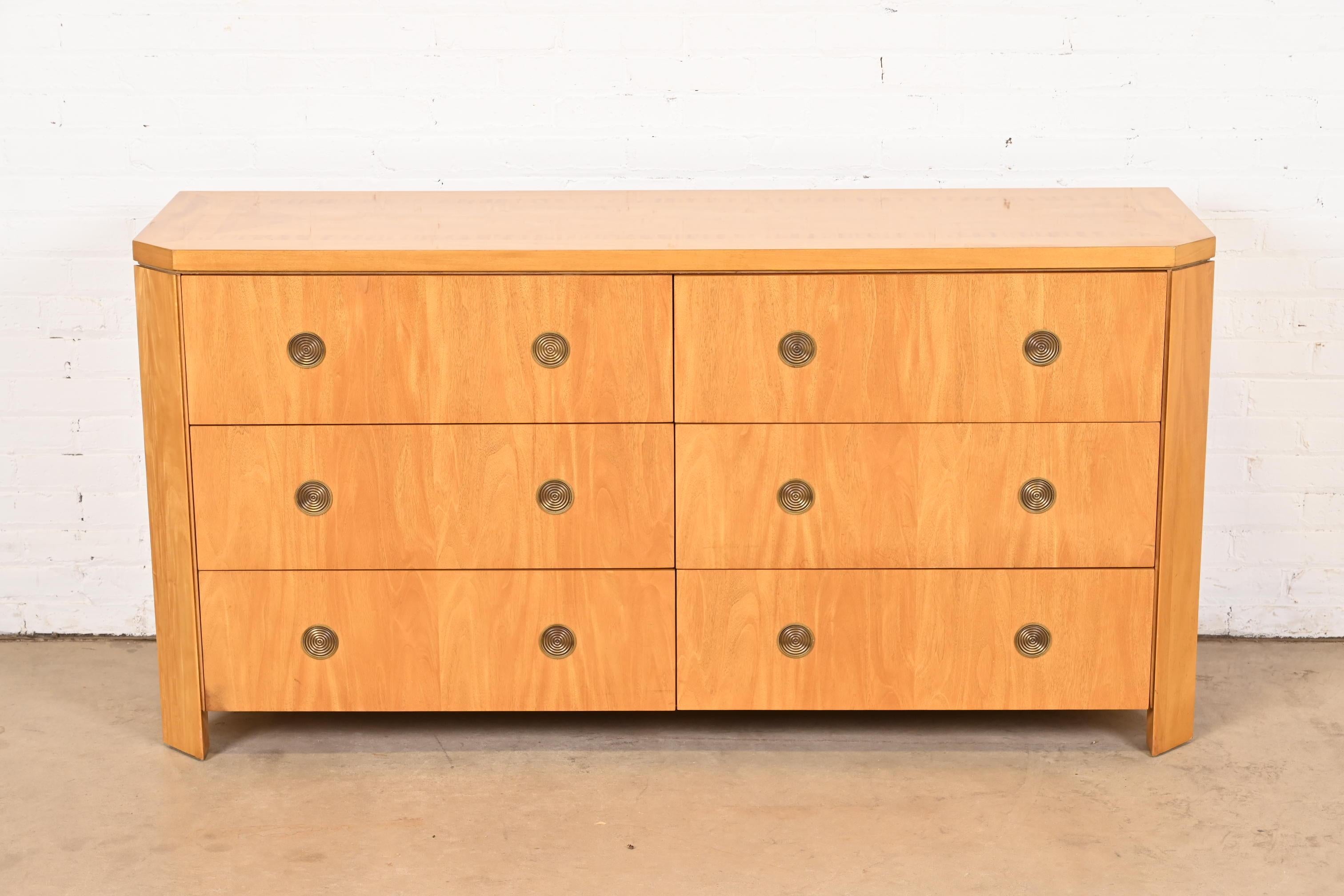 A gorgeous modern Art Deco style six-drawer dresser or credenza

By Charles Pfister for Baker Furniture

USA, 1980s

Primavera (white mahogany) wood, with parquetry inlay and concentric brass pulls.

Measures: 64