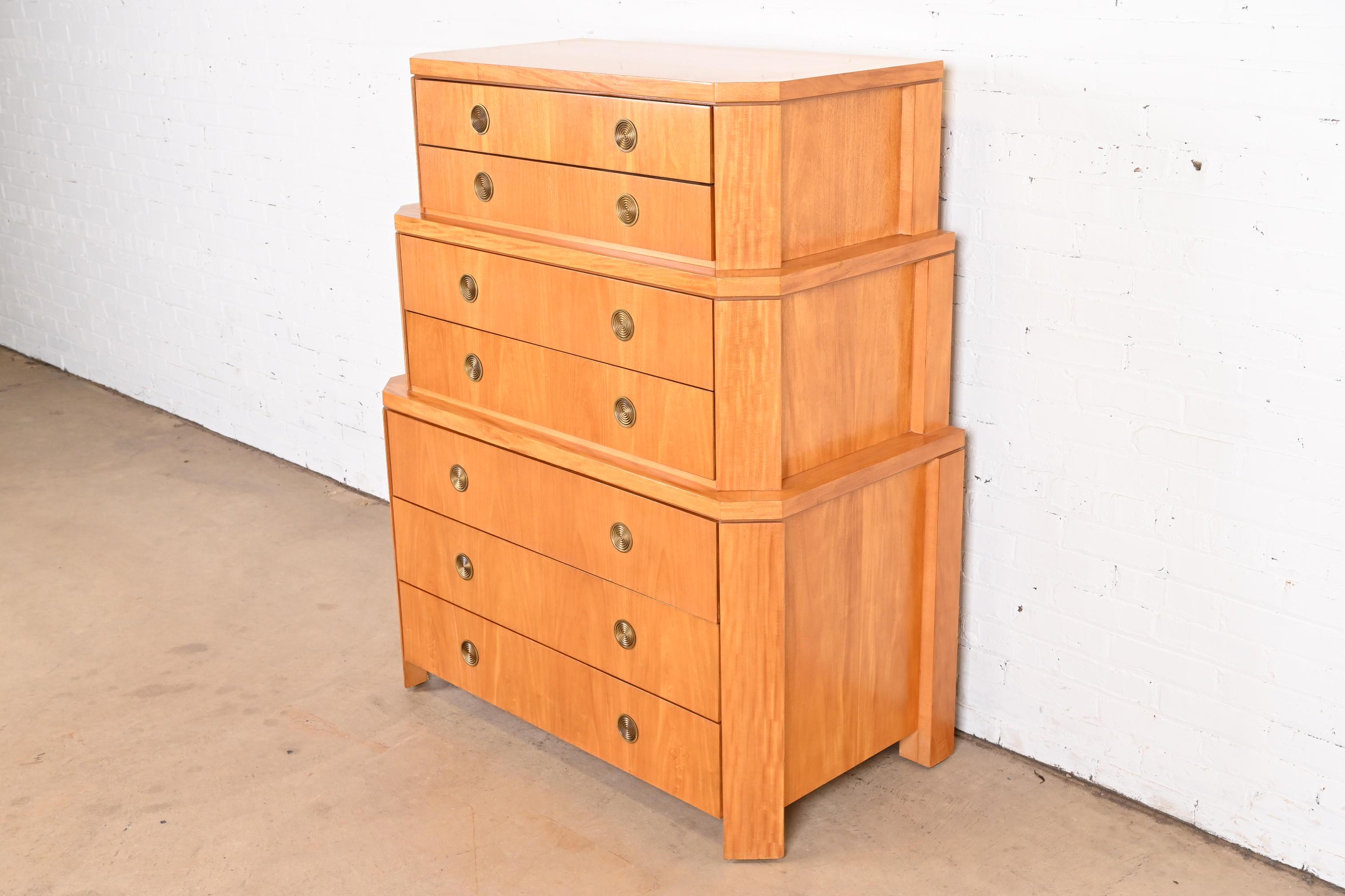 A rare and exceptional modern Art Deco skyscraper triple chest-on-chest highboy dresser

By Charles Pfister for Baker Furniture

USA, 1980s

Primavera (white mahogany) wood, with parquetry inlay and concentric brass pulls.

Measures: 44