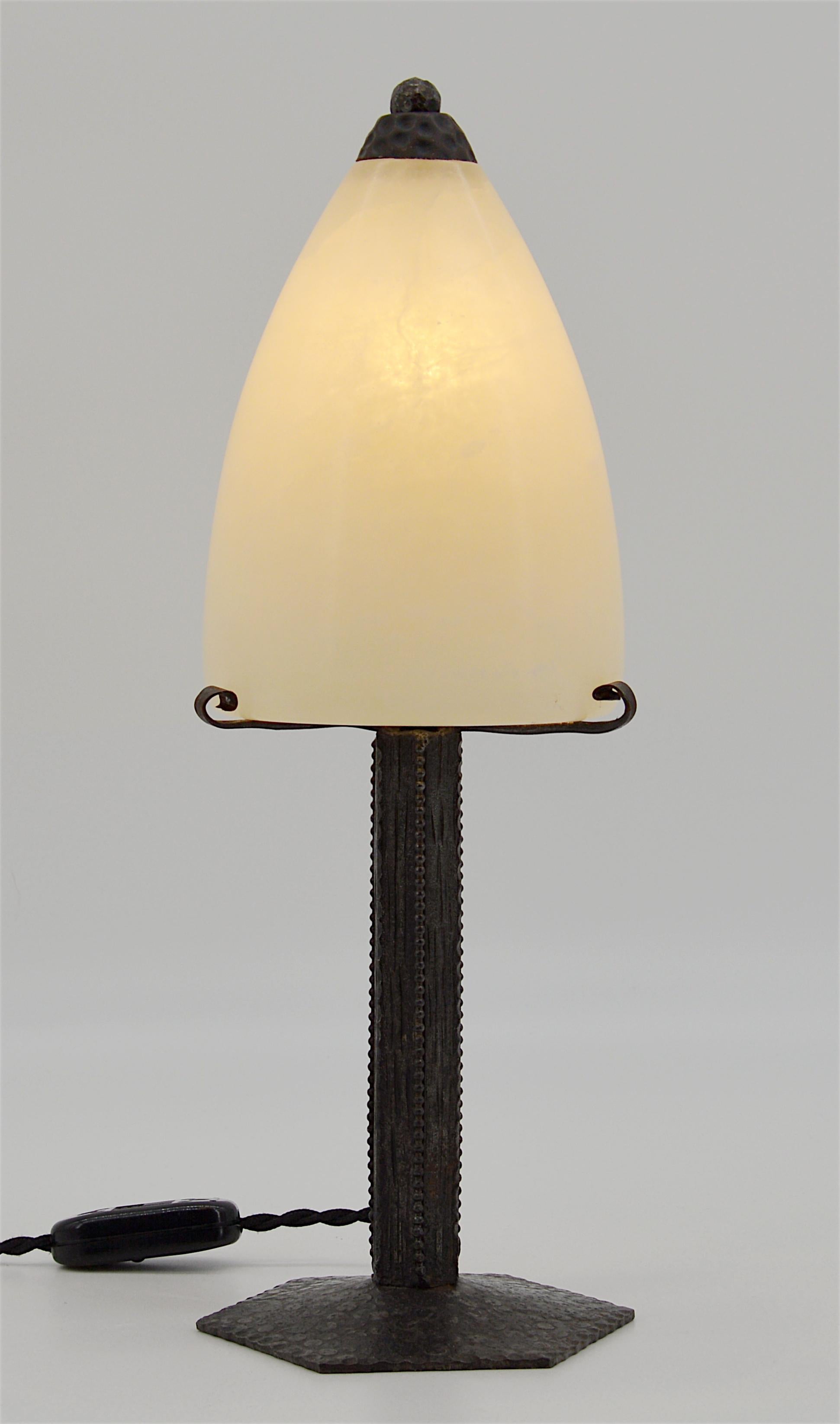 French Art Deco table lamp by the iron worker Charles Piguet, Lyon, France, early 1920s. The precious base comes with its alabaster shade. Measures: Height 13.4