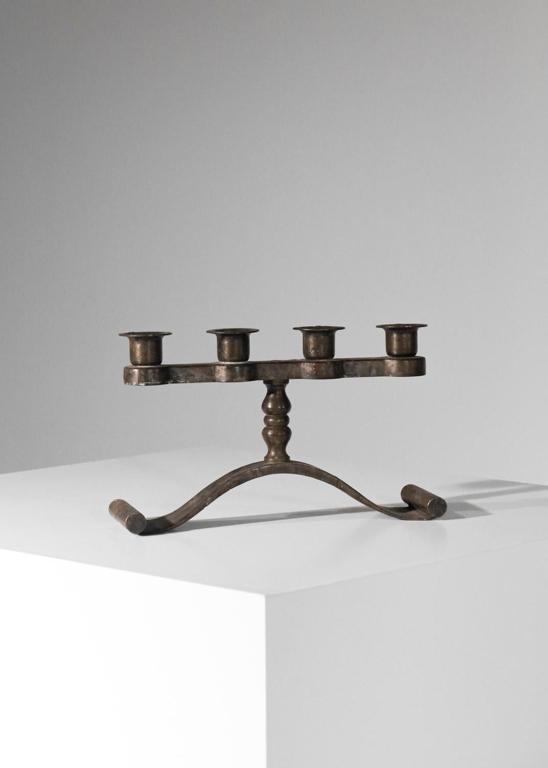 Wrought-iron candlestick from the 30s/40s by Lyon-based wrought-iron artist Charles Piguet. Sober, uncluttered designer with attractive work on the scrolled base. Beautiful patina of age on the entire candlestick (see photos). Artist's signature on