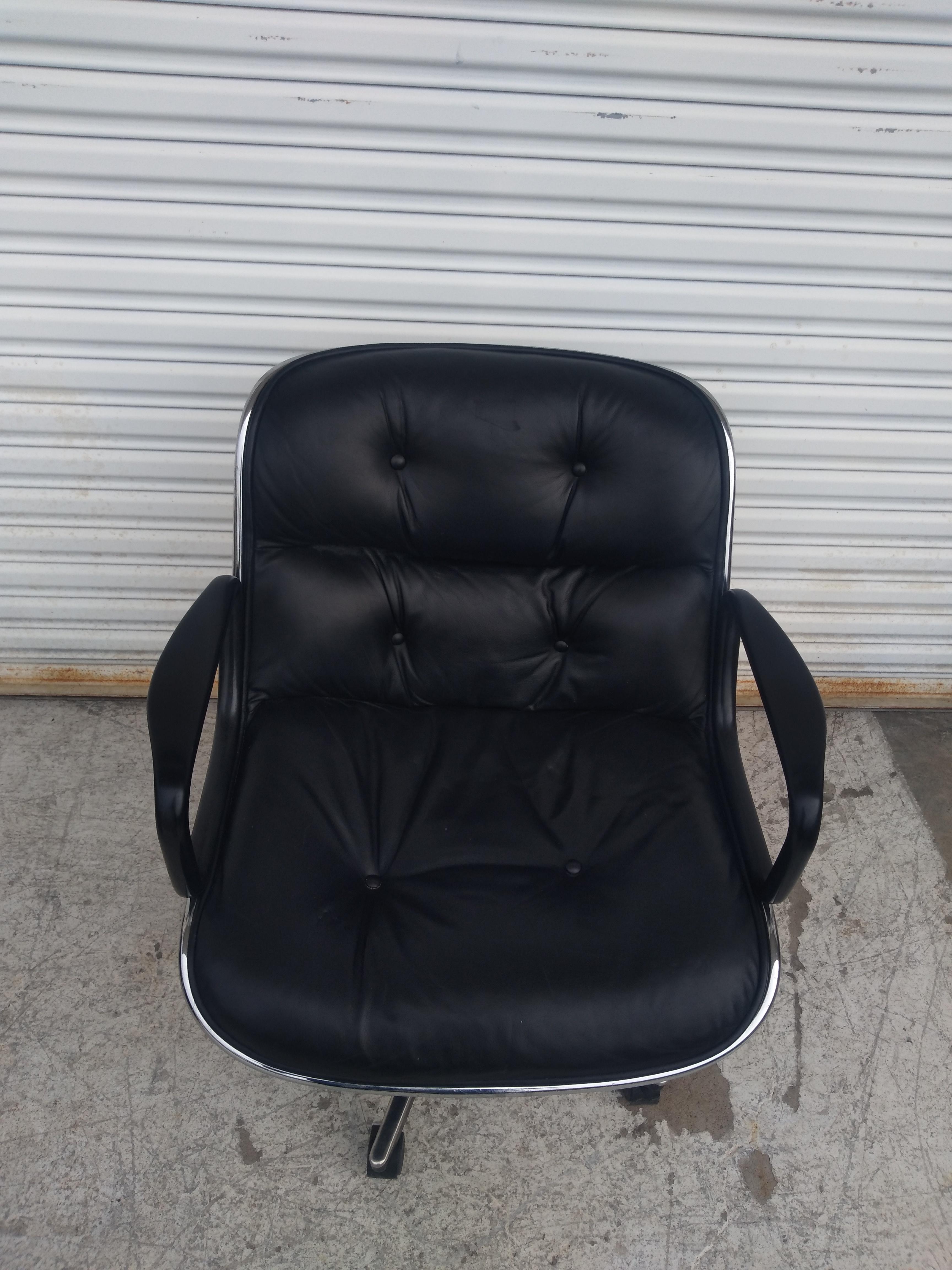 Charles Pollock designed office furniture for Knoll Furniture. This is his executive chair. It sits on a 5 star base with casters. It's upholstered in black Knoll leather. The arms are black to match and the rim is chrome. The 5 star base is chrome