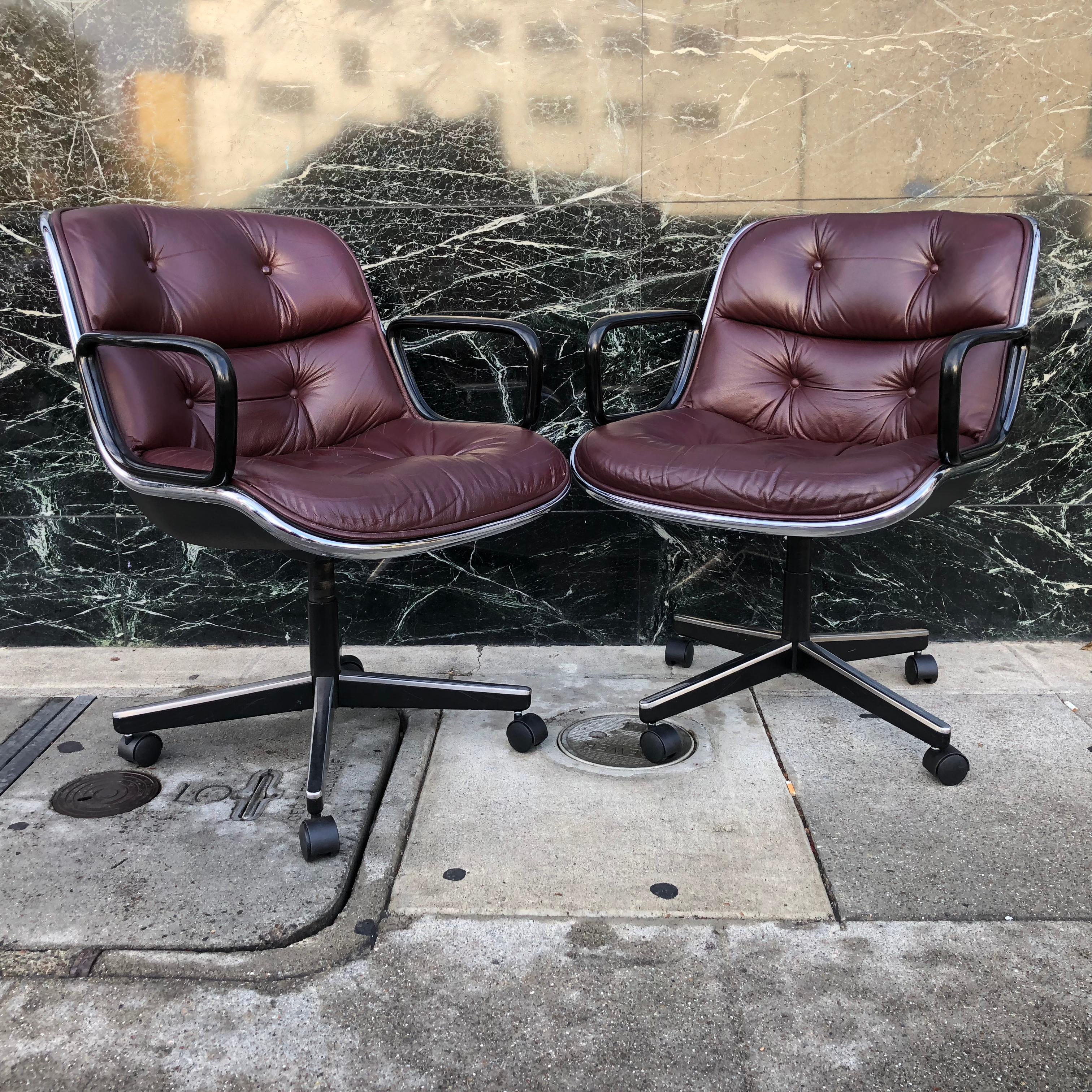 For your consideration are icons of Mid-Century Modern design -- office chairs by Charles Pollock for Knoll. 

These chairs, with a hard plastic back, aluminum frame and tufted leather seat, revolutionized office seating. They have been in