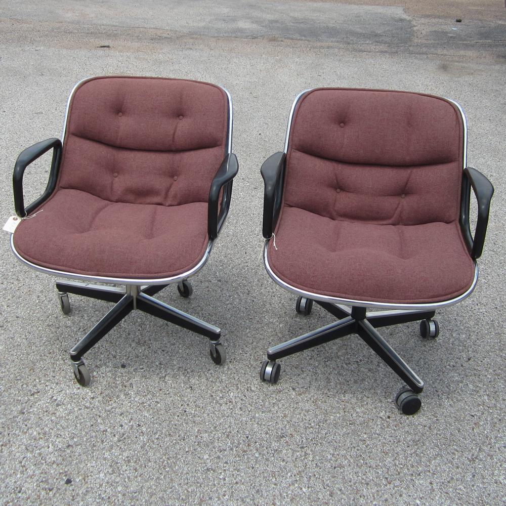 Pair of burgundy fabric Executive arm chairs by Charles Pollock for Knoll International. Chromed steel frame and chromed steel four-star base. Classic Mid Century Modern design.