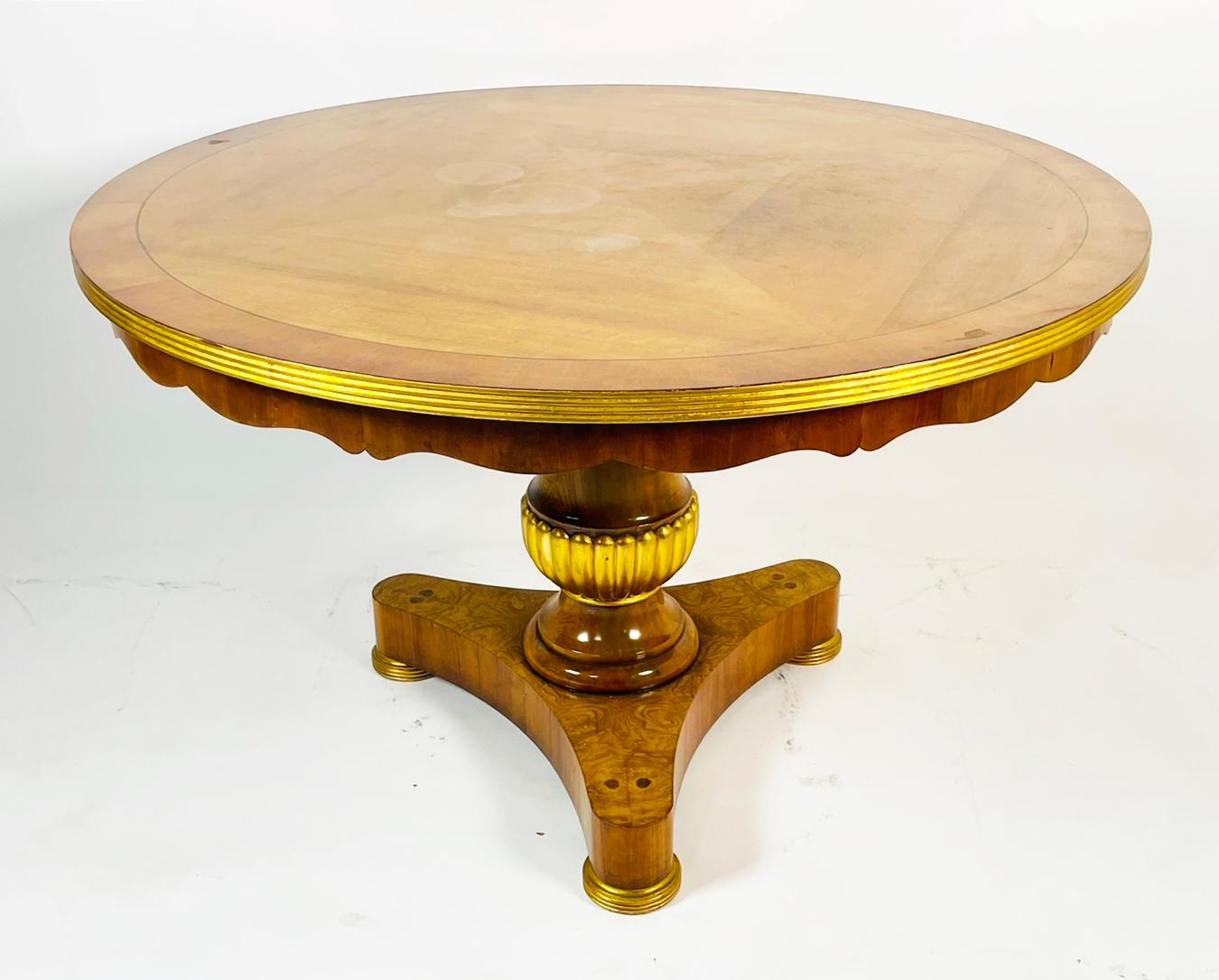 Stunningly beautiful center or dining table designed by Charles Pollock for William Switzer.

The table has a combination of solid woods and veneers such as burlwood on the base along with solid walnut and giltwood accents.

The table retains