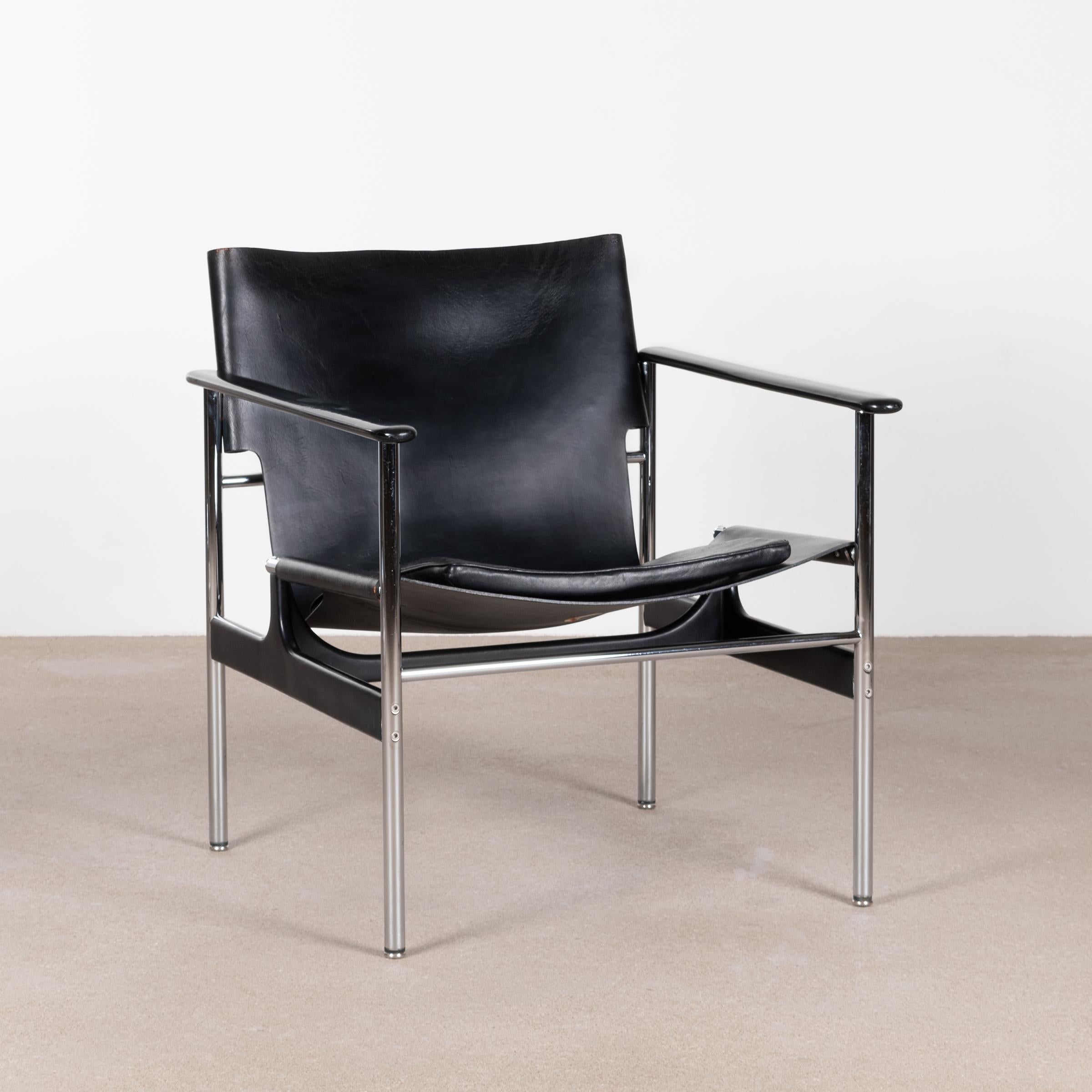 Comfortable easy armchair by Charles Pollock for Knoll. Tubular chrome steel frame, black saddle leather, separate black leather cushion and aluminum arm rests. Chair is signed with manufacture label on both saddle leather as cushion. All in very