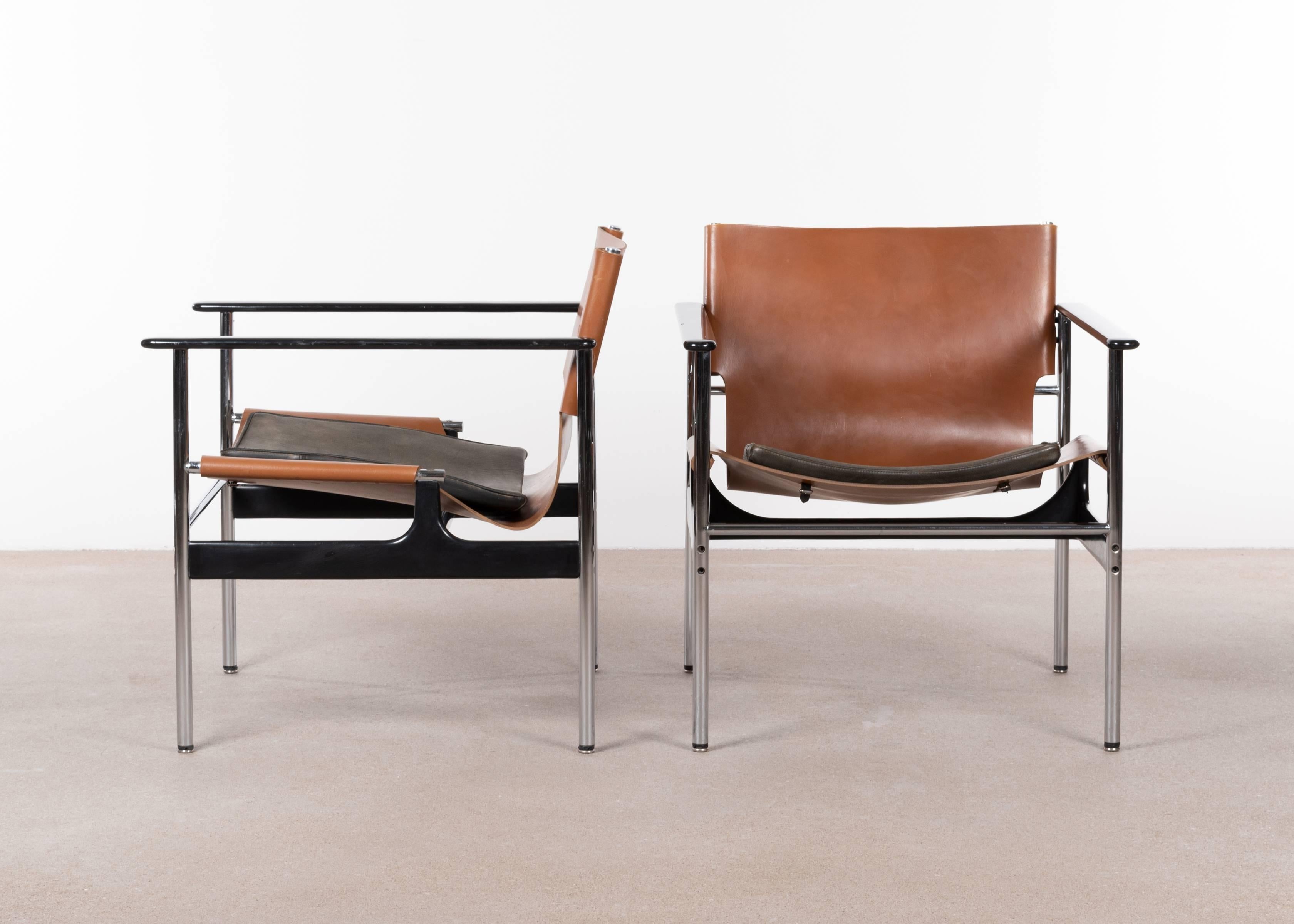 Comfortable pair lounge easy armchairs by Charles Pollock for Knoll International. Tubular chrome steel frame, cognac saddle leather with separate black leather cushions and aluminum arm rests. All in very good condition with slight traced or use.