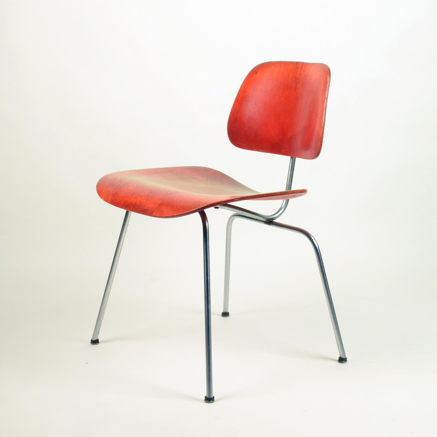 Charles & Ray Eames
Herman Miller, USA (manufacturer)

'DCM' chair, designed 1946, this example manufactured 1951.

Mounded plywood with red aniline dye finish, chromed steel. Stamped to underside '8 51'.
Stunning early example of this