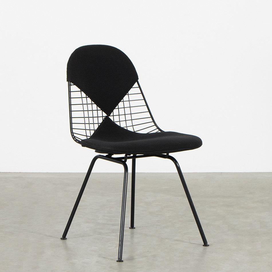 Iconic DKX-2 (dining wire chair X-base) chair designed by Charles and Ray Eames for Vitra. Steel rod shell finished with black powder coating. Assembled on an original H-base powder coated in the same colour. The chair is in very good condition with