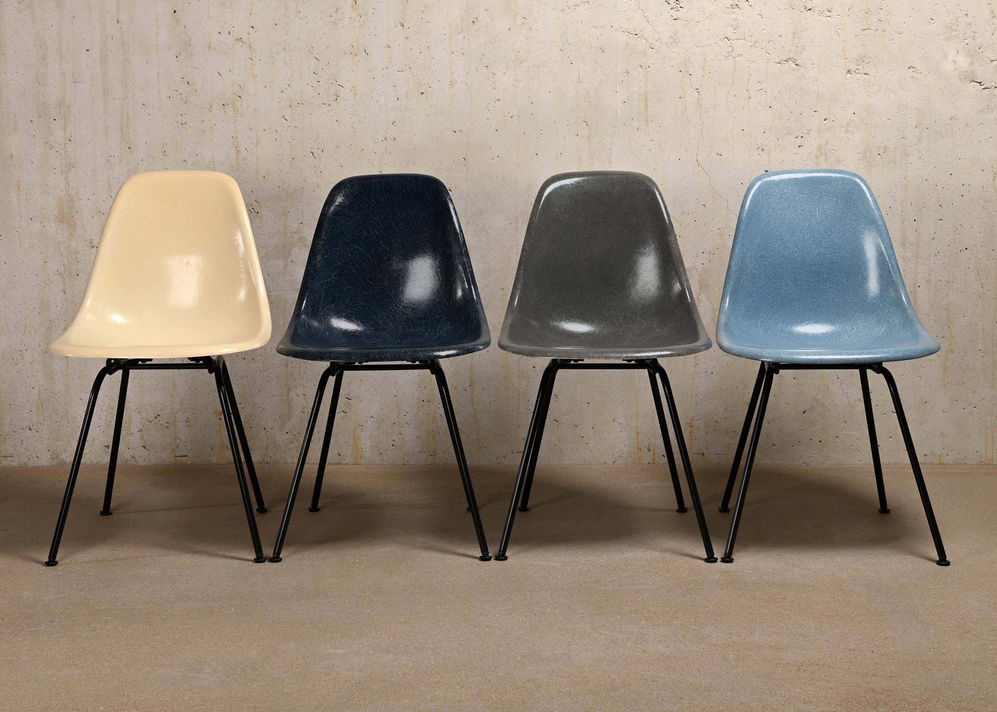 Iconic side chairs designed by Charles and Ray Eames for Herman Miller / Vitra. Molded fiberglass shells in the colours: Parchment, navy blue, elephant hide grey and ocean blue. Assembled on newly powder coated bases in basic dark. The chairs are in
