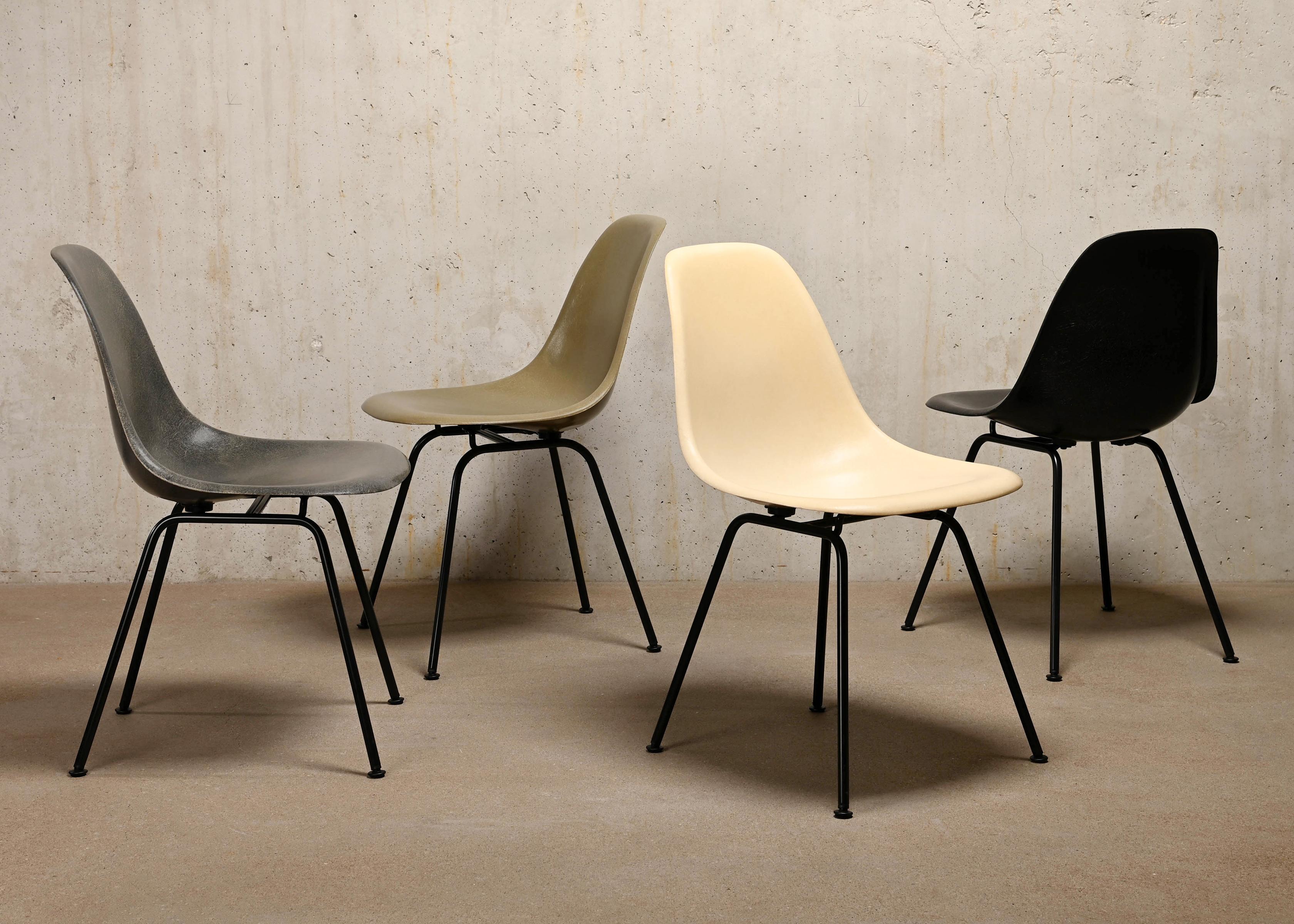 Iconic side chairs designed by Charles and Ray Eames for Herman Miller / Vitra. Molded fiberglass shells in the colours: Parchment, Raw Umber, Elephant Hide Grey and Black. Assembled on newly powder coated bases in basic dark. The chairs are in very