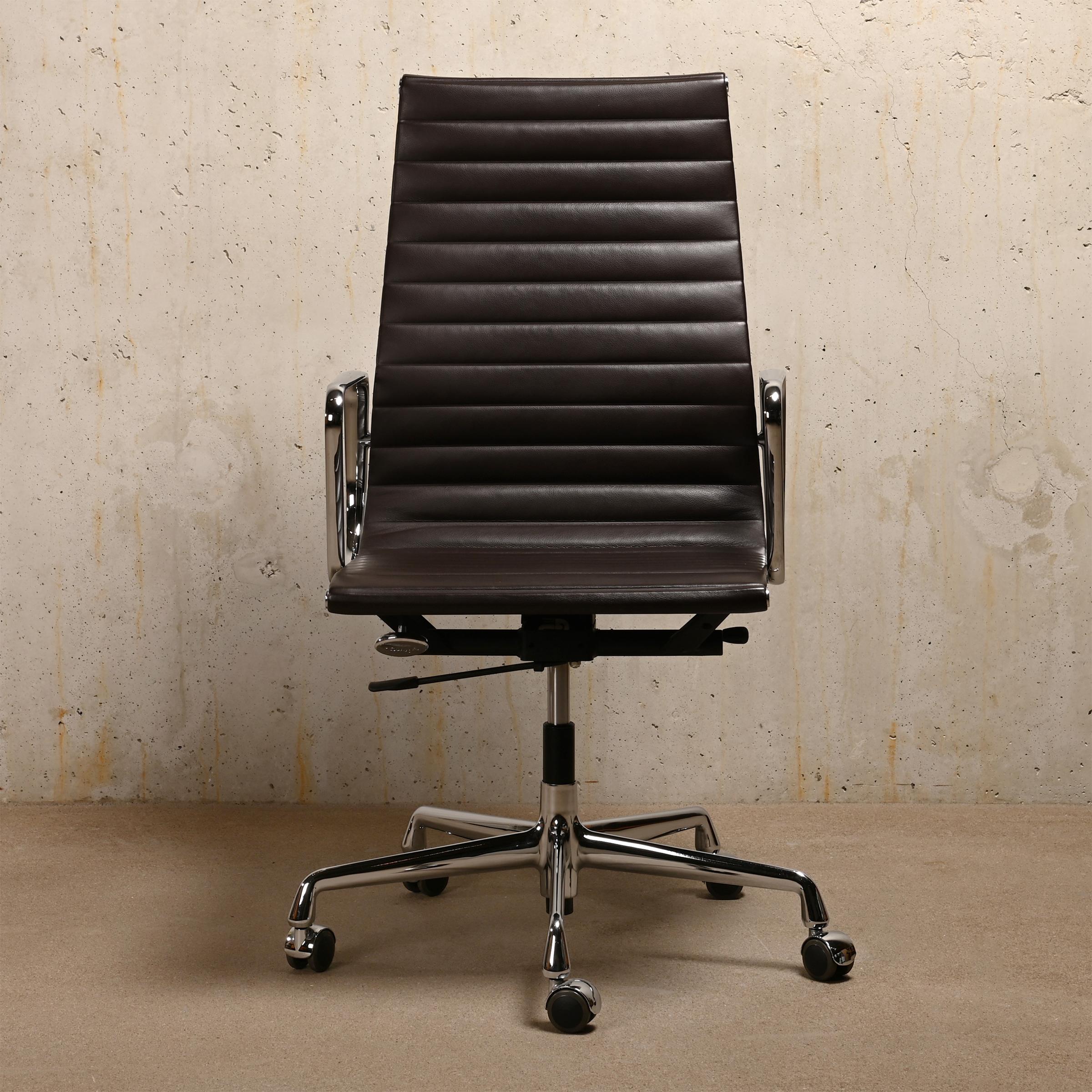 Executive Office Chair, model EA119, designed by Charles and Ray Eames for Vitra / Herman Miller. High backrest and seat in Chocolate dark brown leather. Frame, armrests and five-star base in die-cast aluminium with chrome-plated finish. Seat