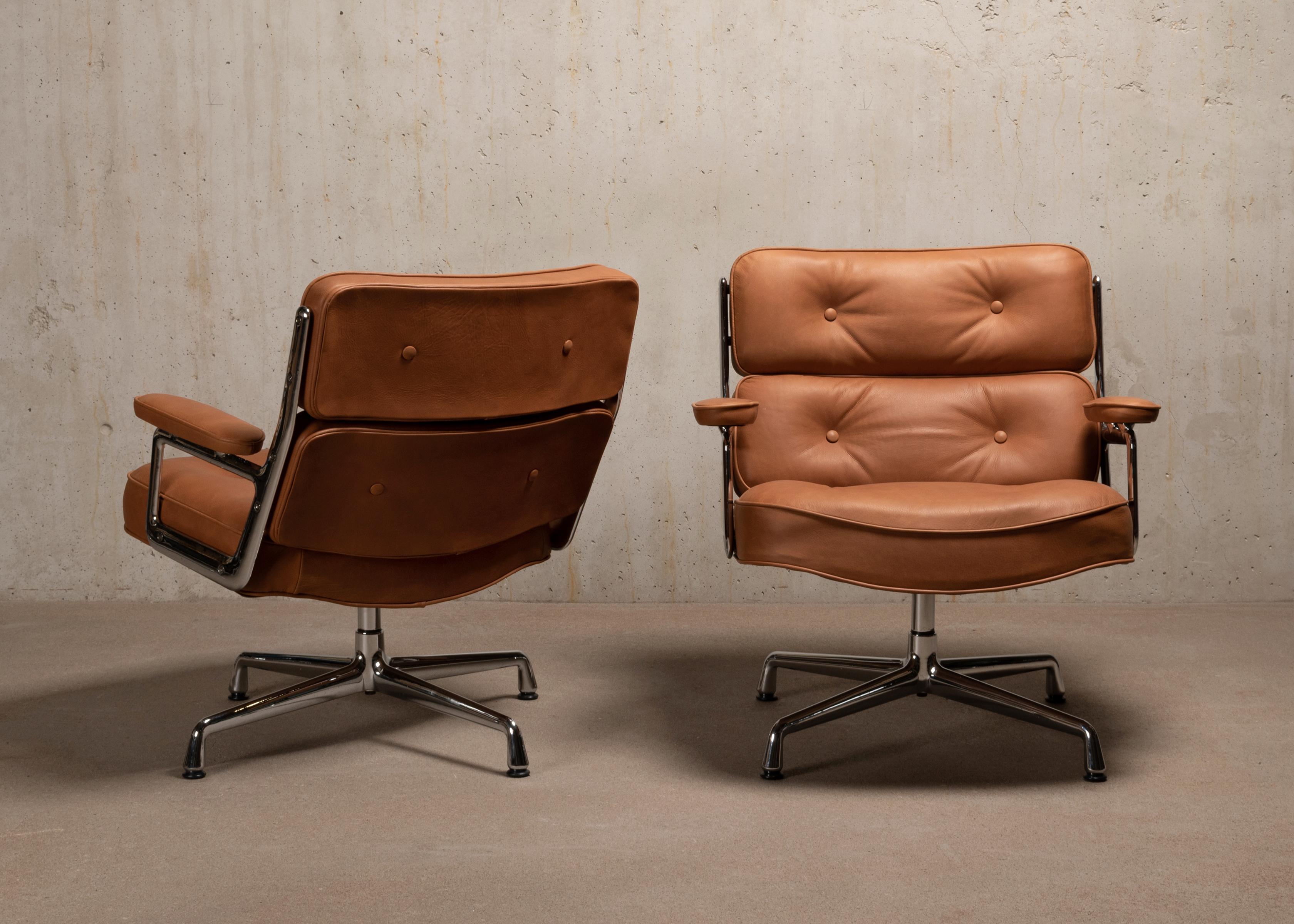 Iconic lounge chairs designed by Charles & Ray Eames for the lobbies in Time & Life Building, Manhattan NY. These chairs are manufactured by Vitra in 1991. Chrome plated aluminum frame with comfortable cushions recently upholstered in cognac