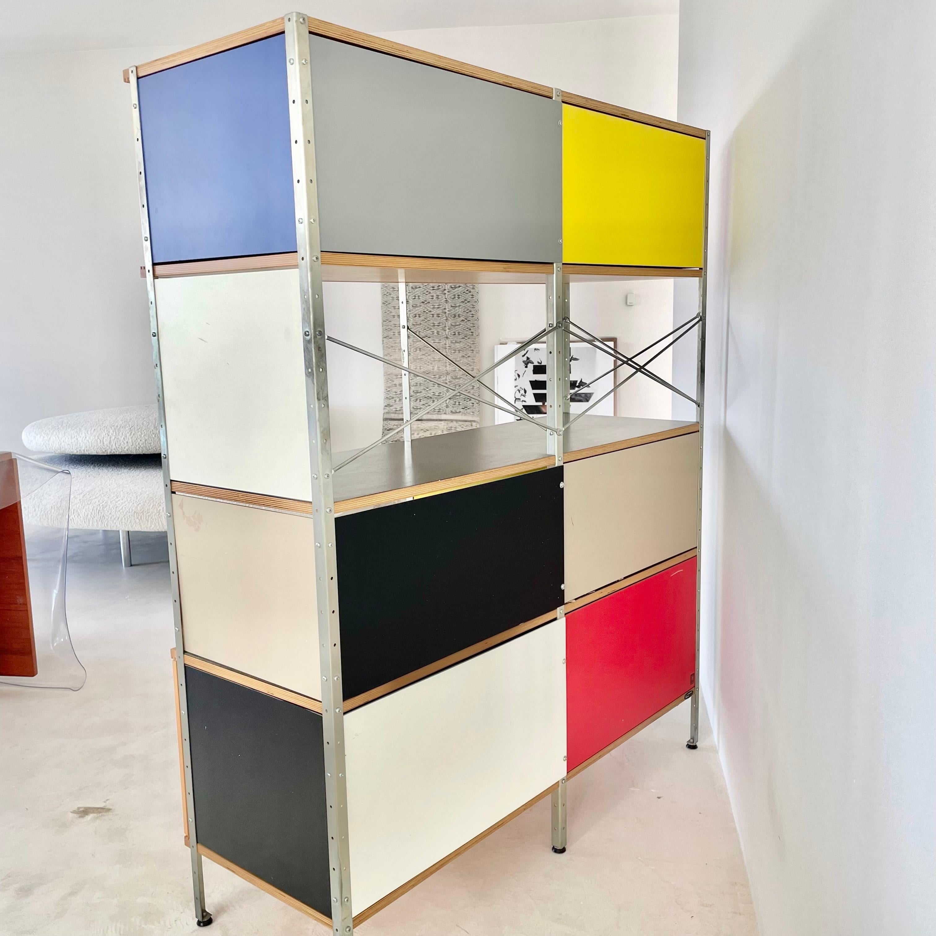 Eames storage unit for Herman Miller made in 1994. Great colors and designs on plywood. Plenty of storage space with wooden panels on the top and bottom. Shelves and 3 drawers in the middle shelf space. In good condition with light wear as shown.