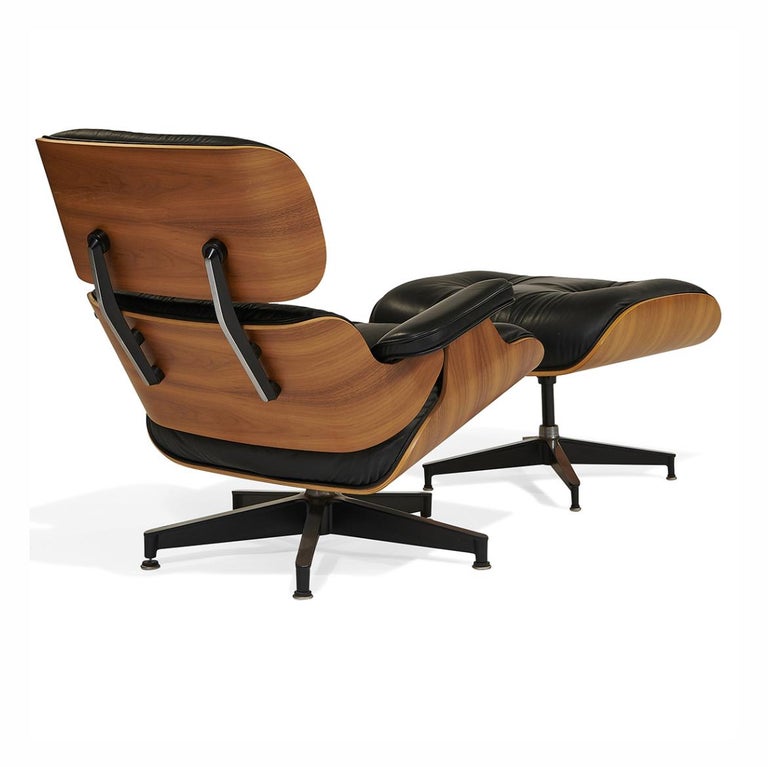 Iconic Charles & Ray Eames for Herman Miller 670 / 671 lounge chair and ottoman. In walnut, black leather, aluminum. 'Eames Office' tags to undersides, includes Herman Miller certificate of authenticity. Zeeland, Michigan.

Measures: Chair: 33