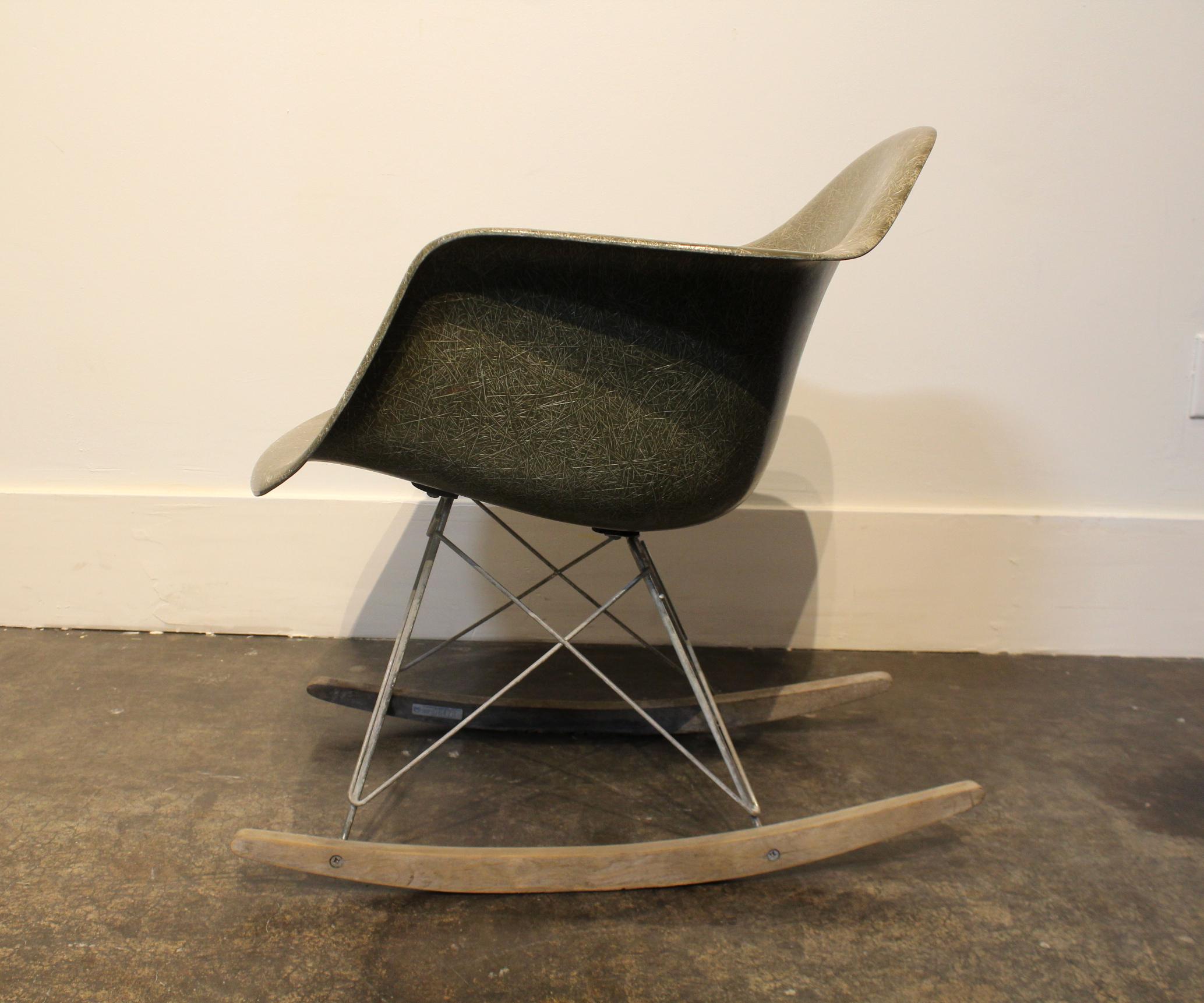 1950s Eames RAR rocker with original shell and legs. Has Herman Miller and Summit Plastics stamps on bottom. Shell has some scratches to headrest and arms but is in good condition. Legs are in fair condition, metal shows signs of oxidation and rust,