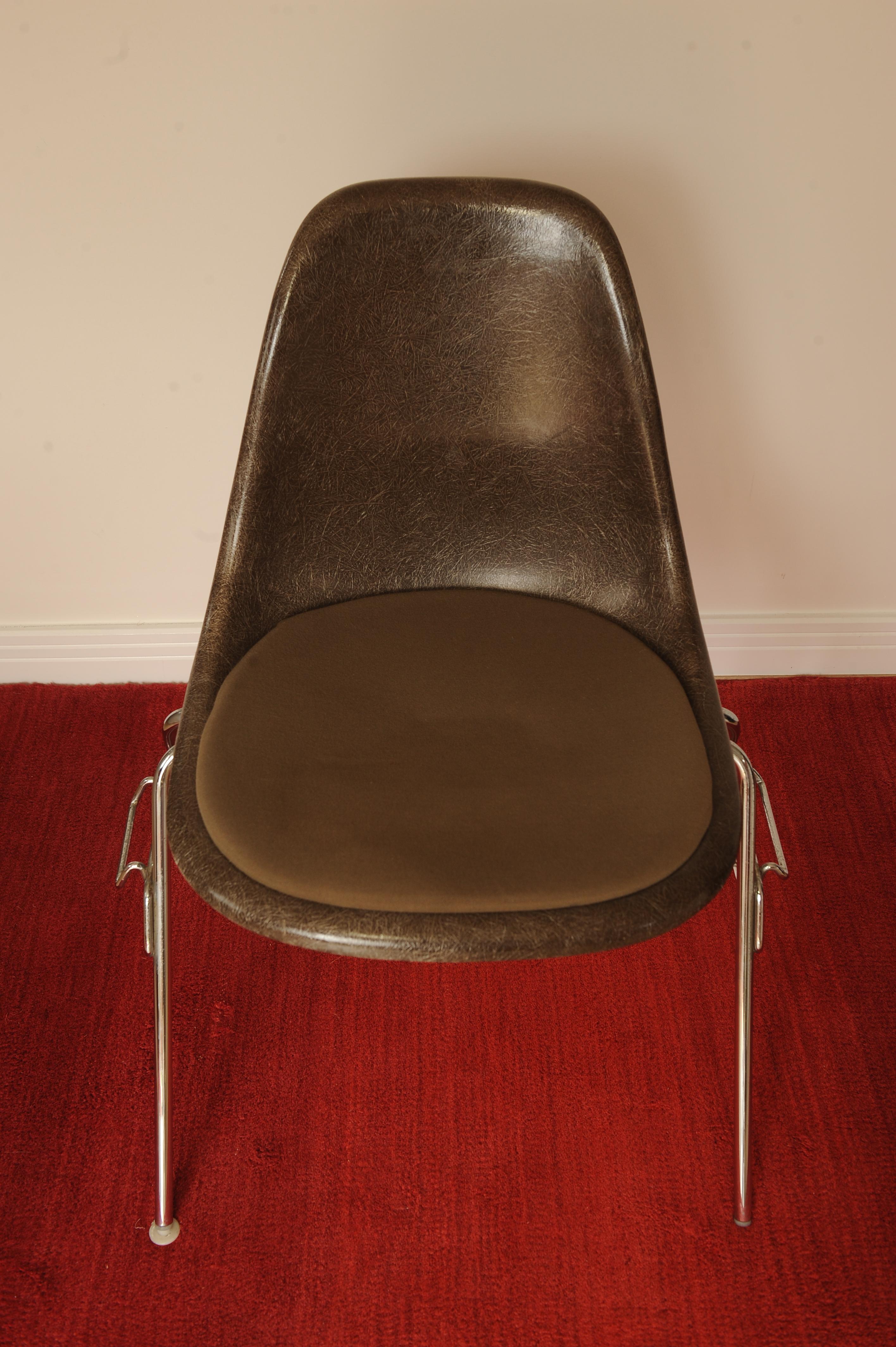 Charles & Ray Eames Herman Miller original DSS fiberglass chrome stacking chair with brown upholstered cushion afixed to chair seat. Labelled with makers mark to base of chair.

 