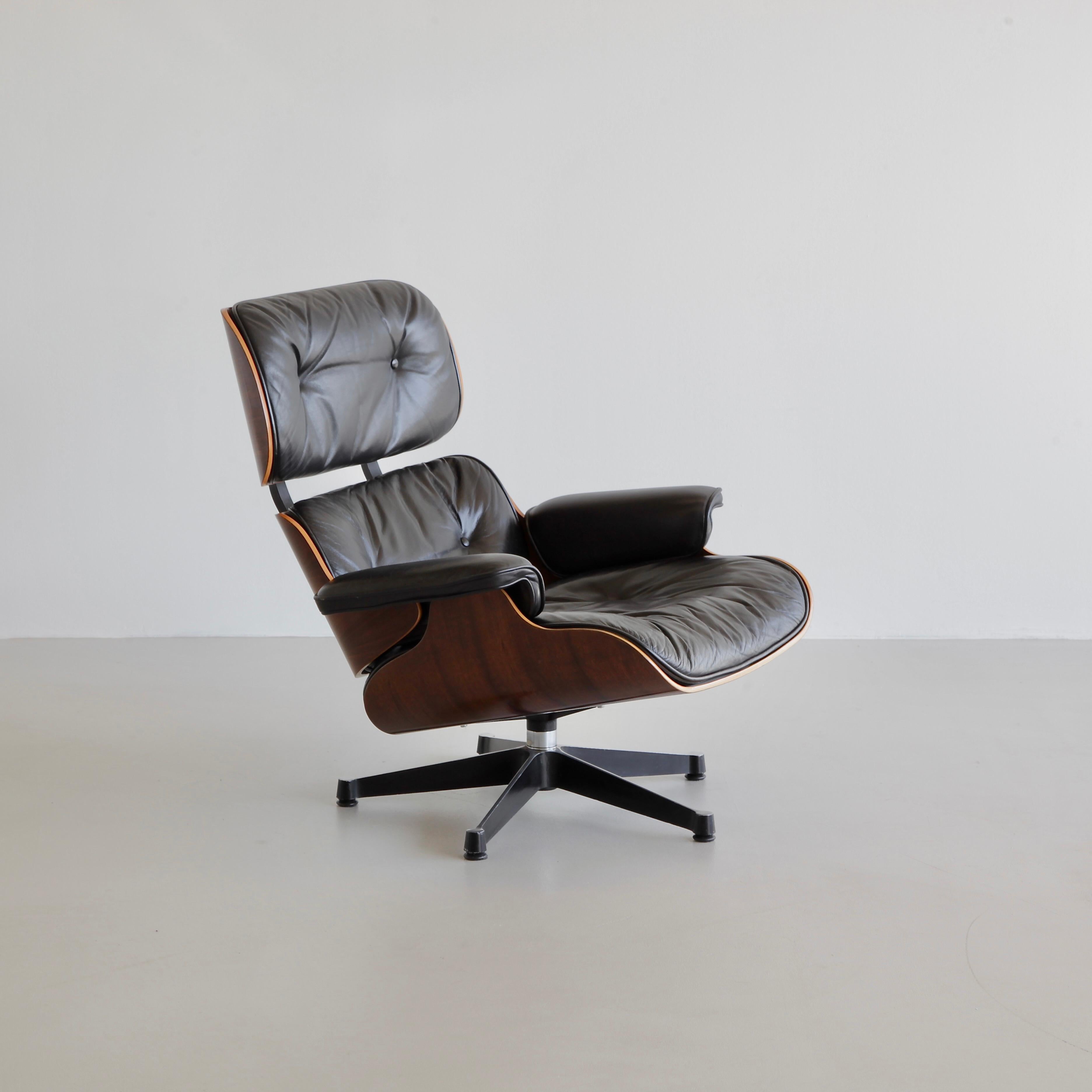 Lounge Chair and ottoman, designed by Charles and Ray Eames in 1956. Germany, VITRA, 1970s.

Beautiful original lounge chair with rosewood shell and subtle black leather upholstery. The original maker's labels, both under the chair and footstool