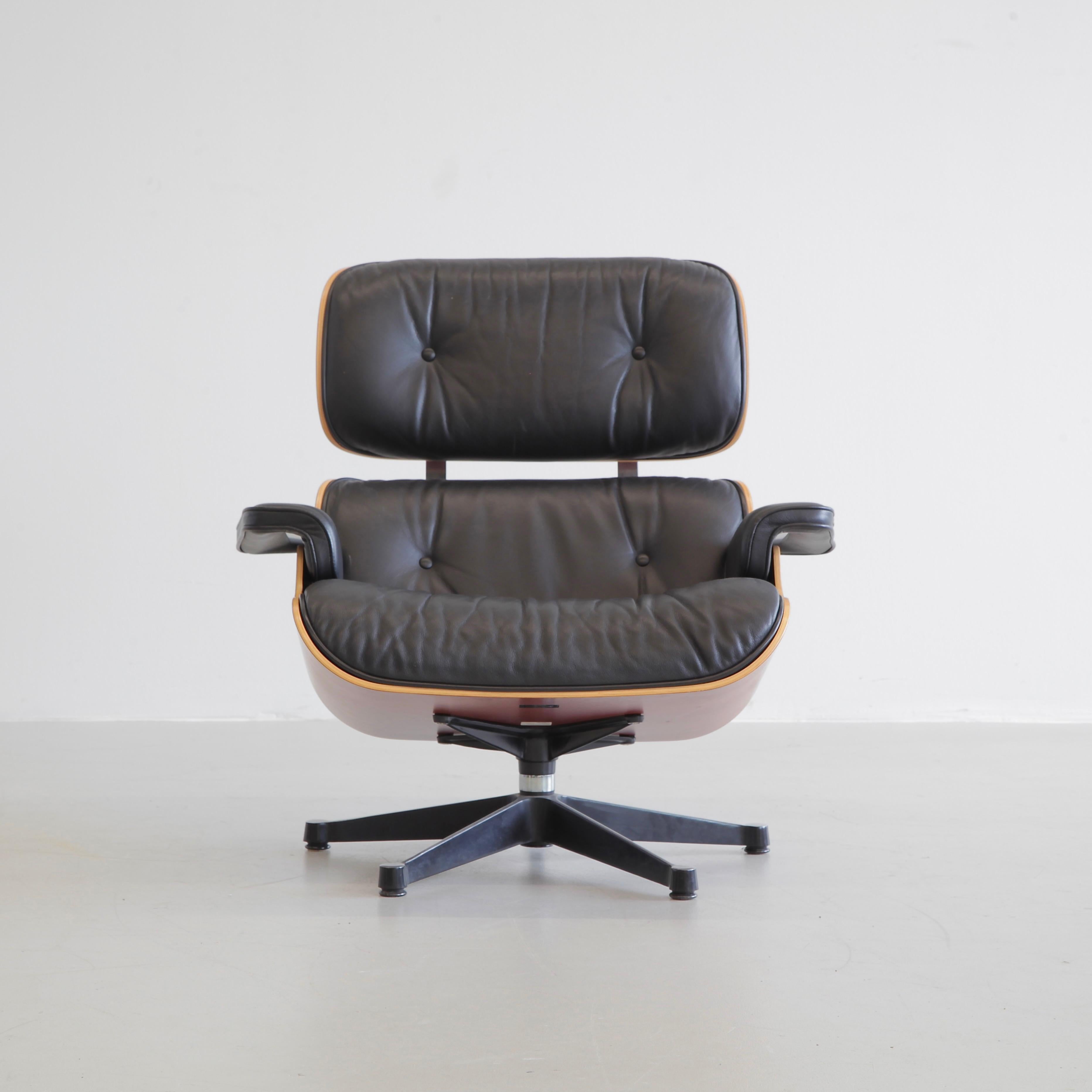 Lounge chair and ottoman, designed by Charles and Ray Eames in 1956. Germany, Vitra, 1999.

Beautiful original lounge chair with cherrywood shell and subtle black leather upholstery. The original maker's labels are both present under the chair and