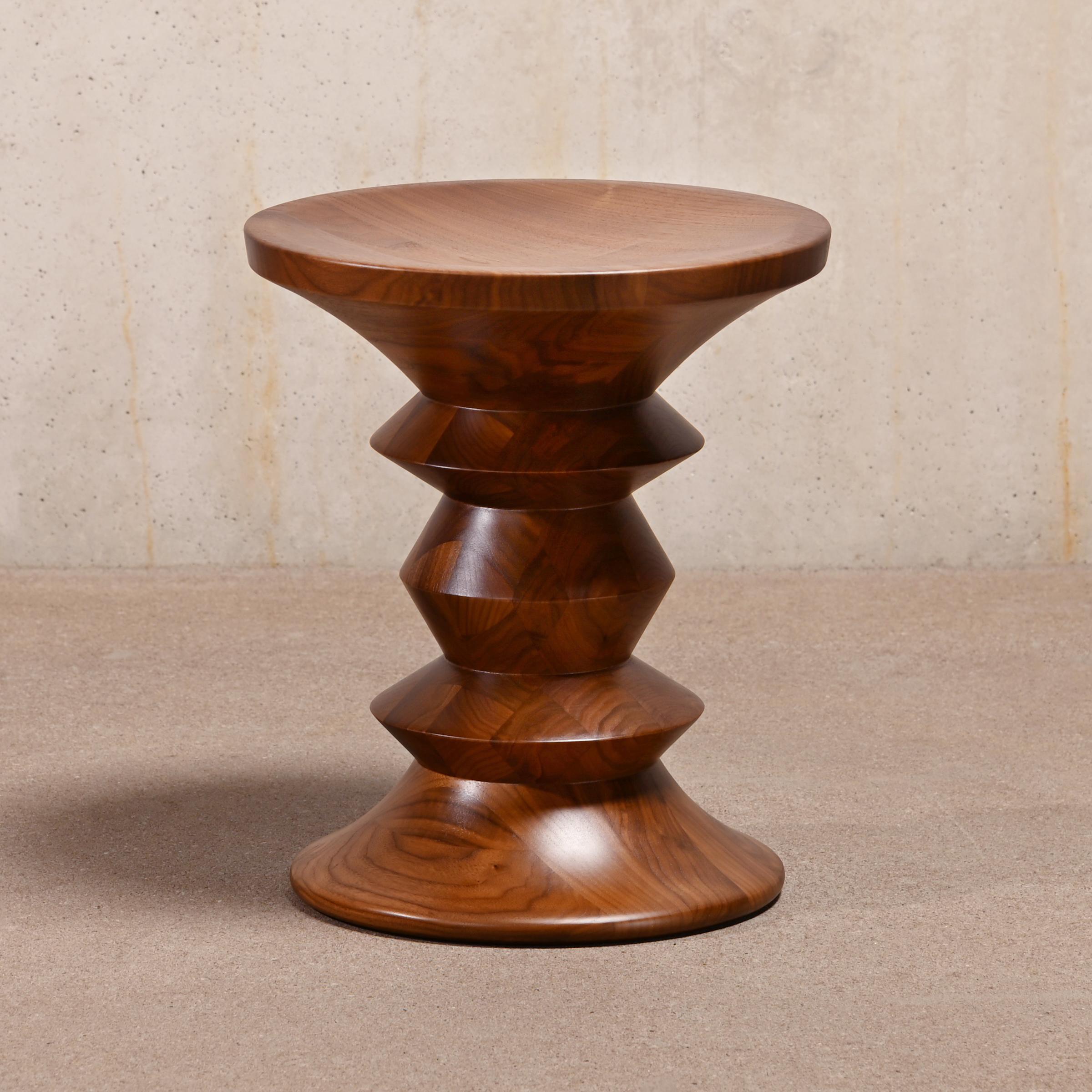Beautiful solid walnut stool (Model A). One of the many design icons by Charles and Ray Eames and originally designed for three lobbies at New York's Rockefeller Center in 1960. The Stool is a charming addition to many lounge chairs and sofas and