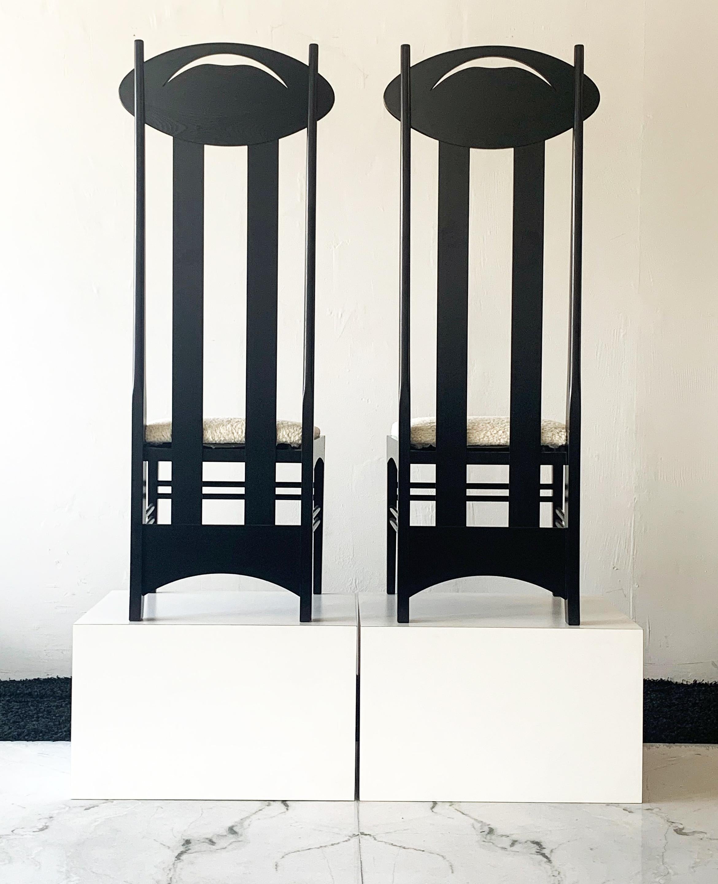These chairs are absolutely stunning. A pair of iconic Charles Rennie Mackintosh Argyle chairs upholstered in white boucle. The Charles Rennie Mackintosh Argyle Chair was designed for Miss Cranston's Tea Rooms in Argyle Street, Glasgow. The high