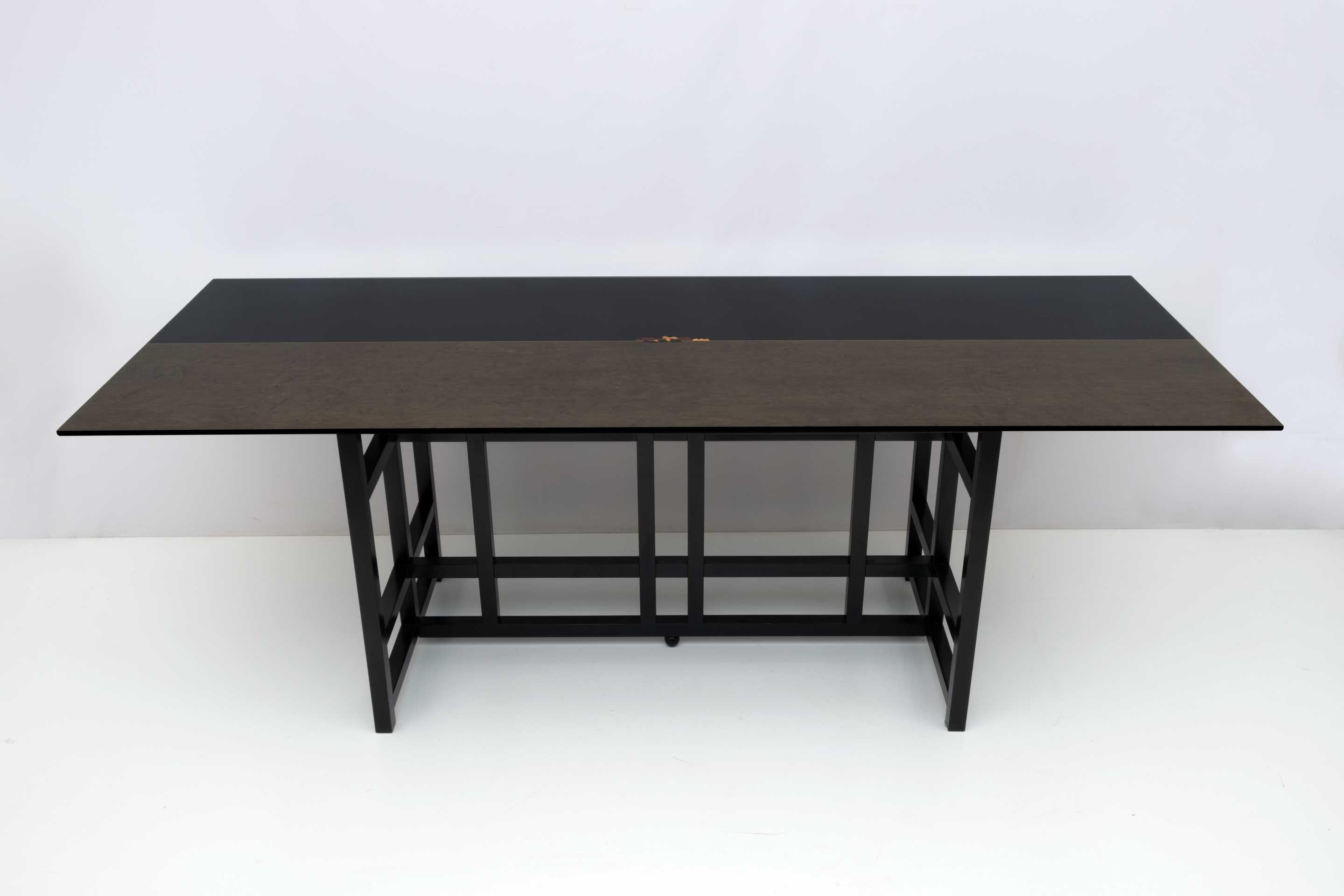 Beautiful table, Italian production from the late 1970s, in the style of Charles Rennie Mackintosh. In black lacquered wood, the top was made in black lacquered wood and grey-brown tinted erable briar, with central inlay.