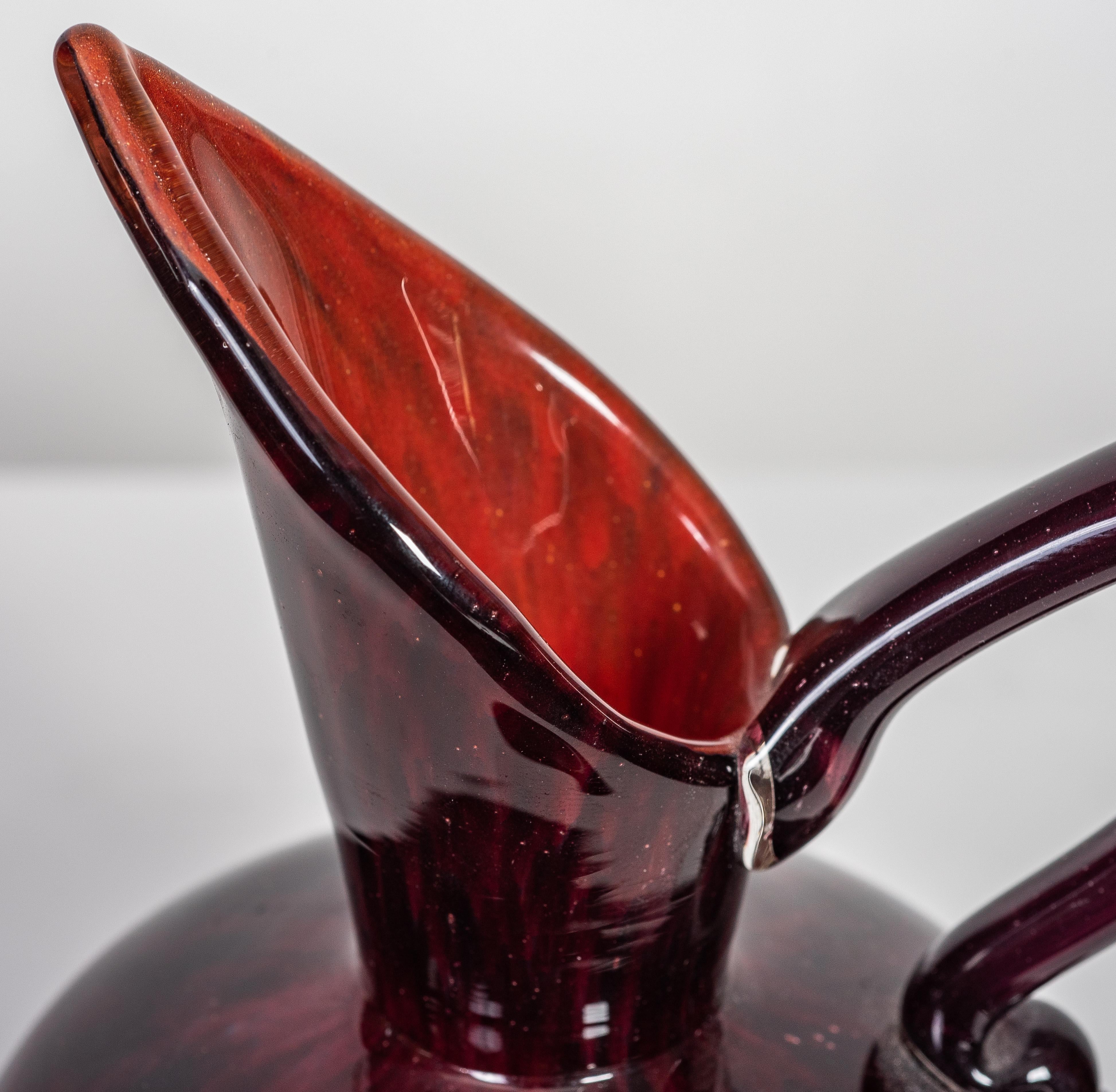 Charles Schneider (1881-1953)
Internally decorated glass jug with applied handle on a mottled red ground, circa 1924-1925, etched signature Schneider
Dimensions 
Height 
6.5 in. (16.5 cm) 
Width
4.5 in. (11.4 cm).