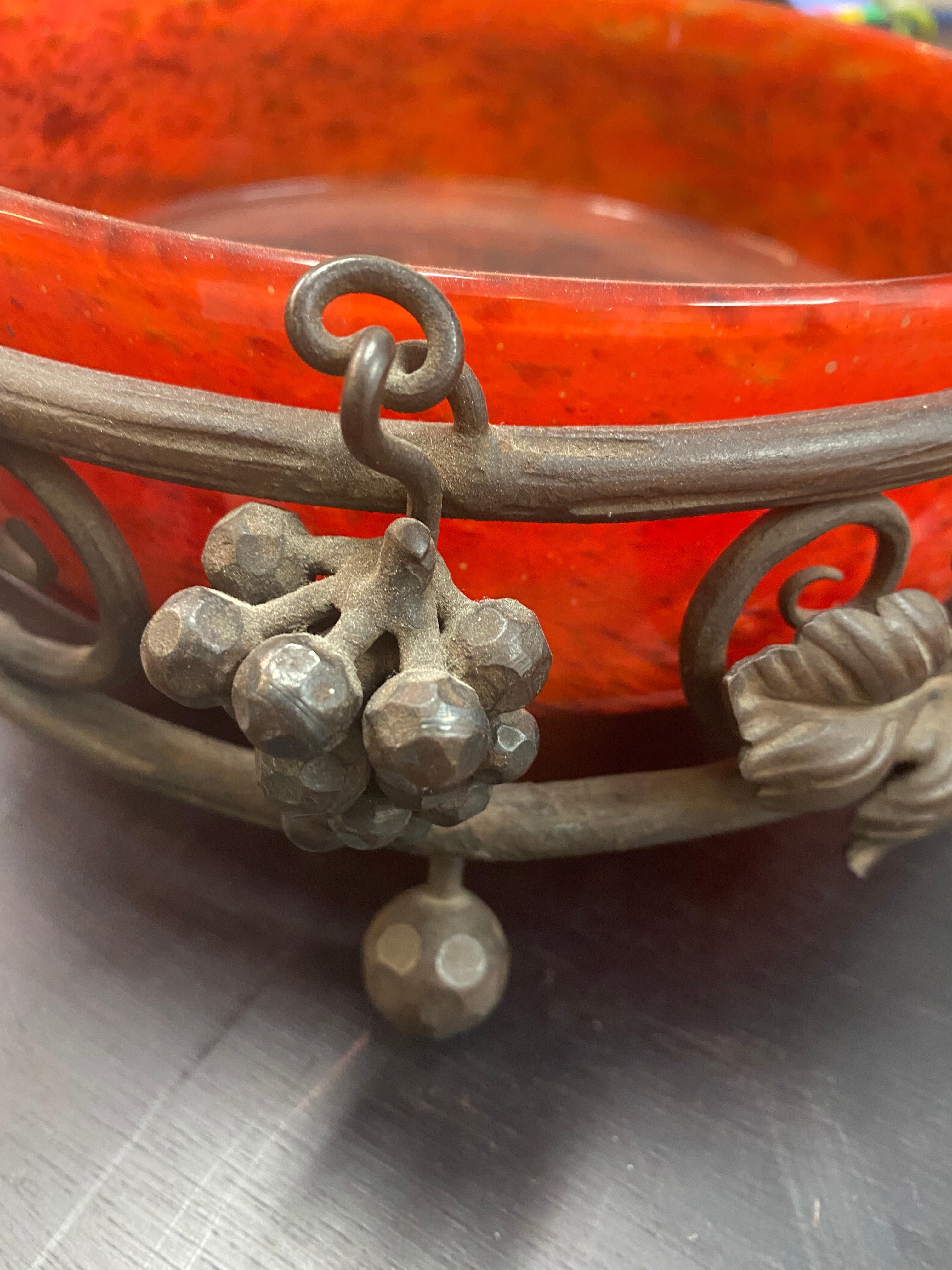 Charles Schneider (1881-1953)
A fine Art Deco Schneider glass and wrought iron bowl,
circa 1920
clear amber glass with orange, purple and pink powders, on patinated wrought iron carrying base with leaves and glass beads
engraved