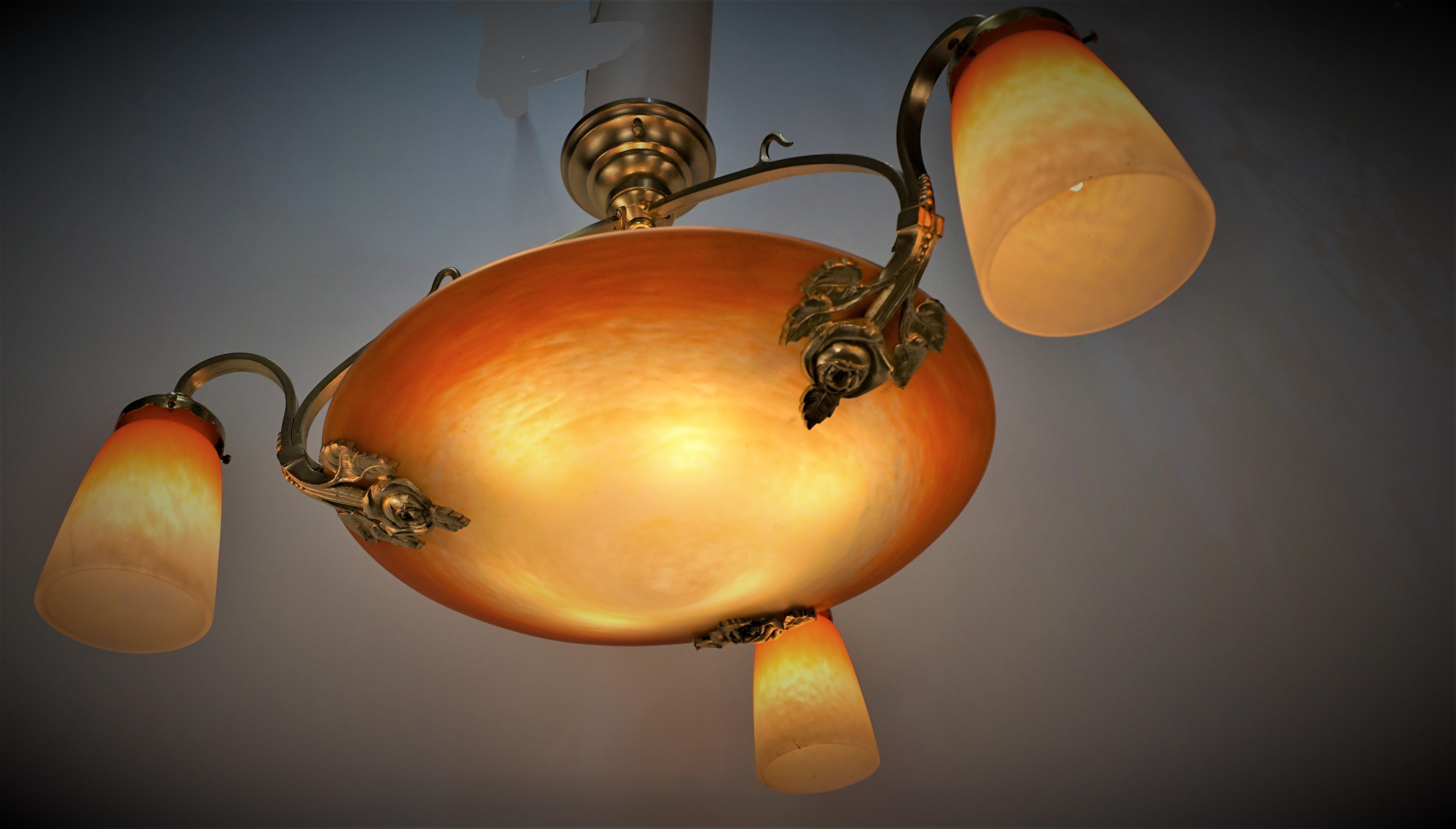 1920's French Art Deco chandelier by Schneider France. Superb mottled blown center and side glass shades, Colors: Orange, yellow to whitish clear frost with short bronze frame.