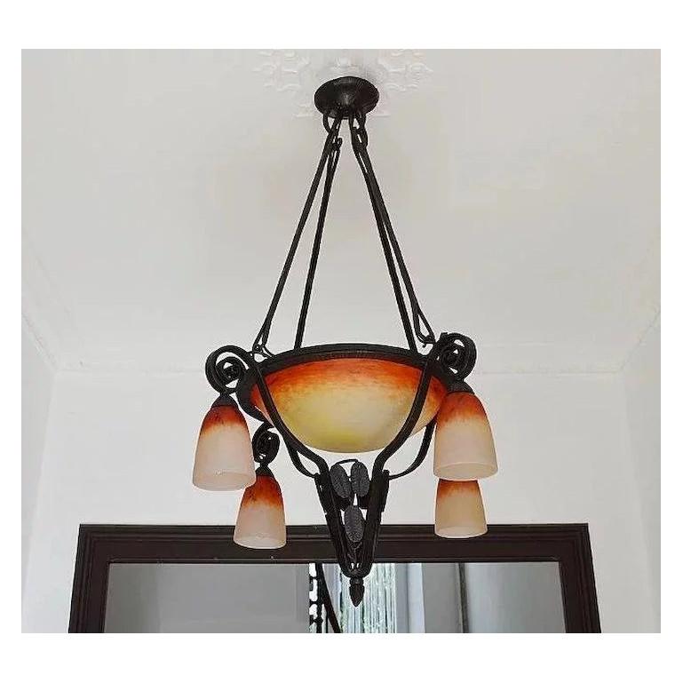 French Art Deco chandelier by Schneider (Epinay-sur-Seine, Paris) France, circa 1925. Mottled blown double glass shades, colors: Red, orange, purple, yellow and white. Top wrought iron fixture. Signed 