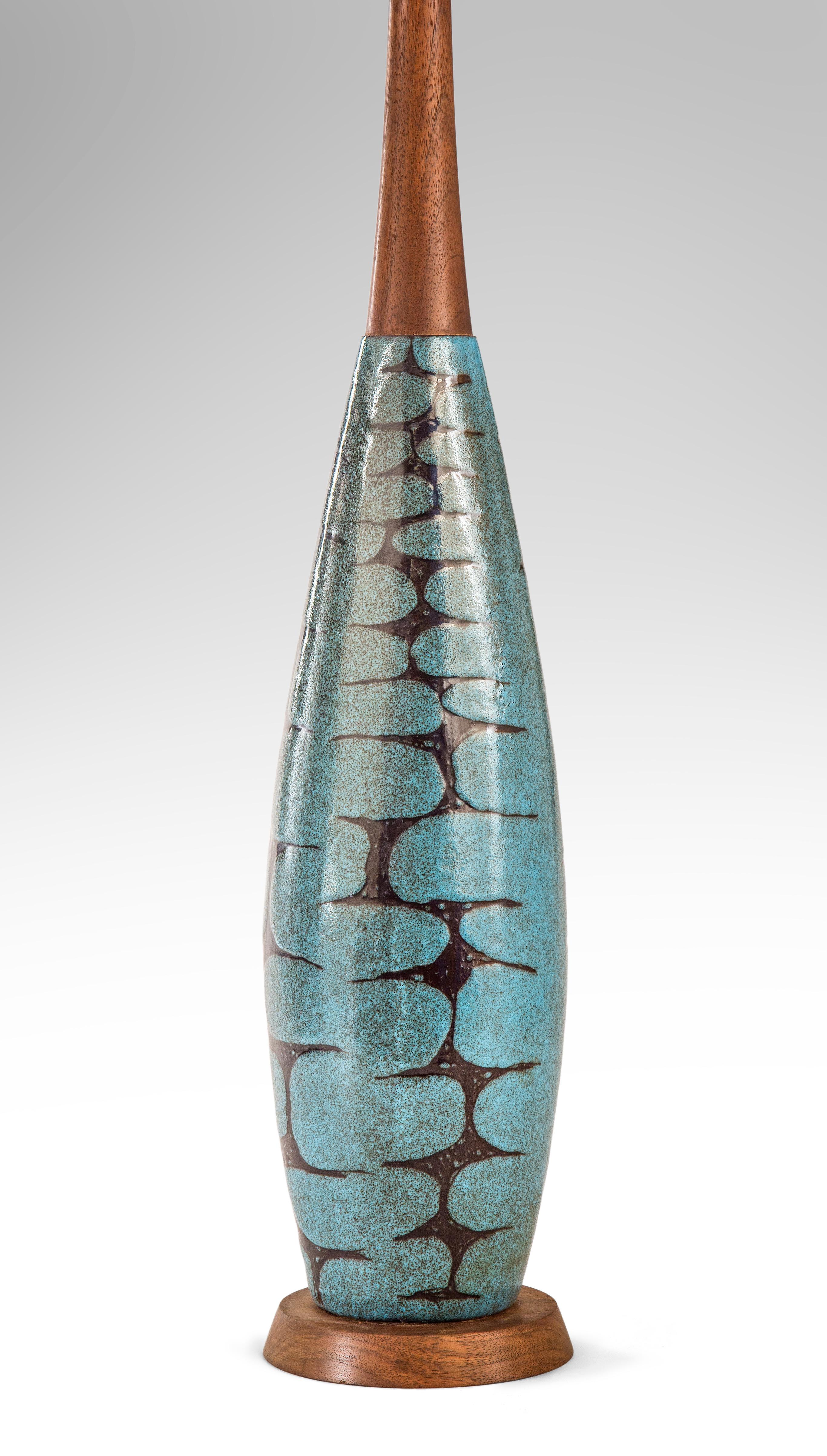 A blue-green glazed bottle form ceramic lamp,
circa 1970
With this lamp the ingenious Charles Sucsan unites elegant form with vibrant color and pattern. The tapering bottle form with a classic mid century patterned glaze.
Great condition, ready