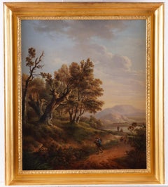 A wooded landscape with a traveller on a path