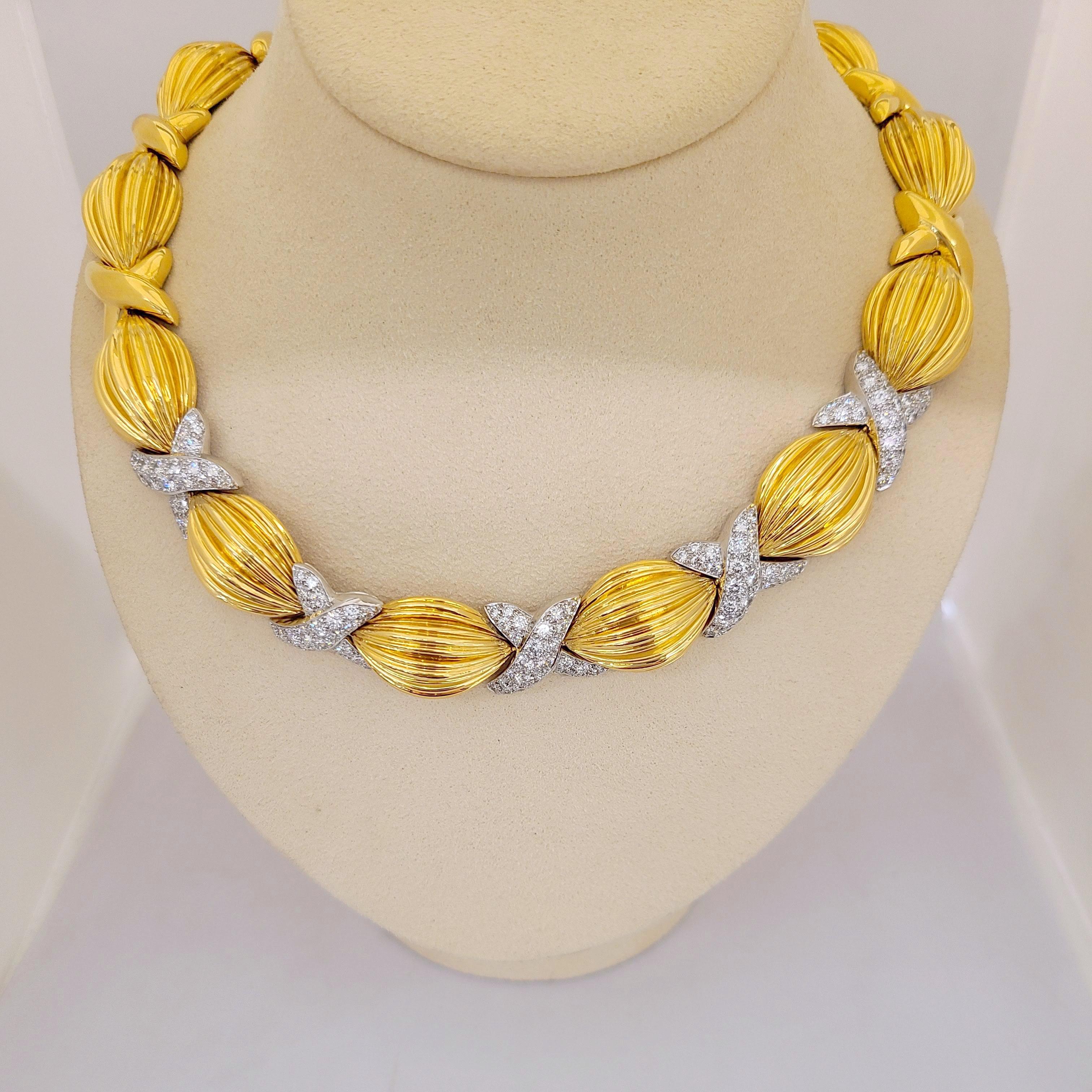 Designed by the legendary Charles Turi Jewelry Company, this  magnificent classic necklace is crafted in 18 karat yellow gold and platinum. Created with 13 fluted oval sections divided with 5 x's which have been beautifully set with pave diamonds.