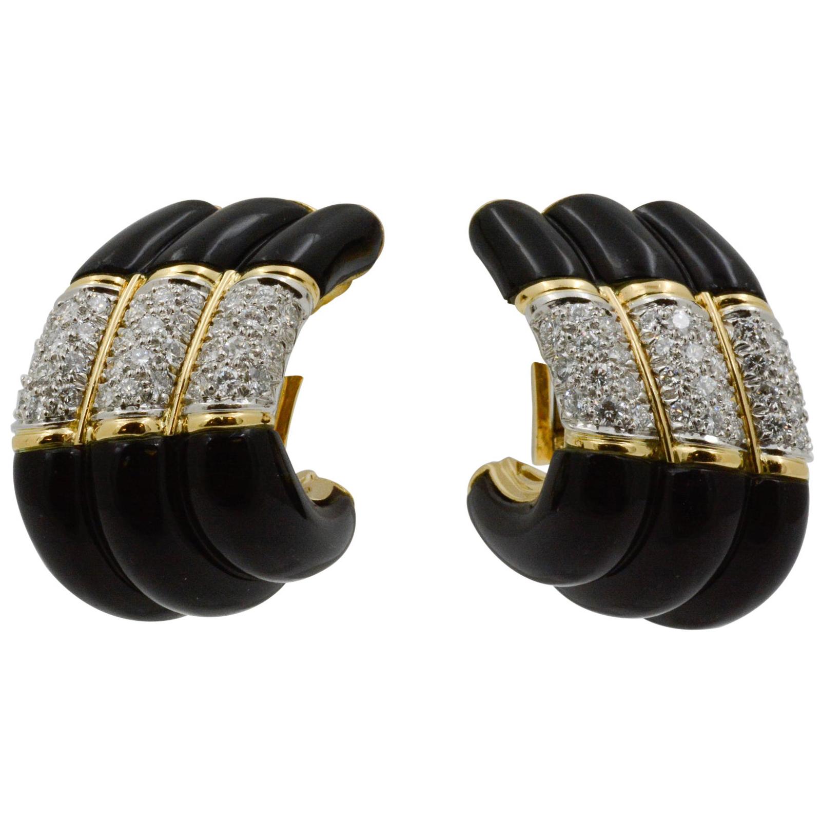 Exclusively from the Eiseman Estate Jewelry Collection, these Charles Turi 18k yellow gold earrings feature three black onyx panels and are accented by 66 round brilliant cut diamonds weighing 1.75 carats with G-H color and VS clarity. 