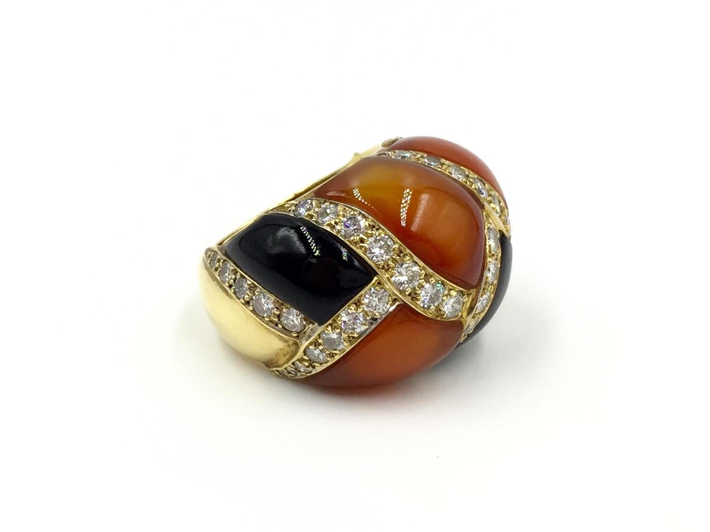 Brilliant diamonds, warm carnelian and glossy onyx come together beautifully in this unique cocktail ring by Charles Turi. Made in 18k yellow gold, this ring has a total diamond weight of 2.16 carats, approximately F color, VS clarity, that are set