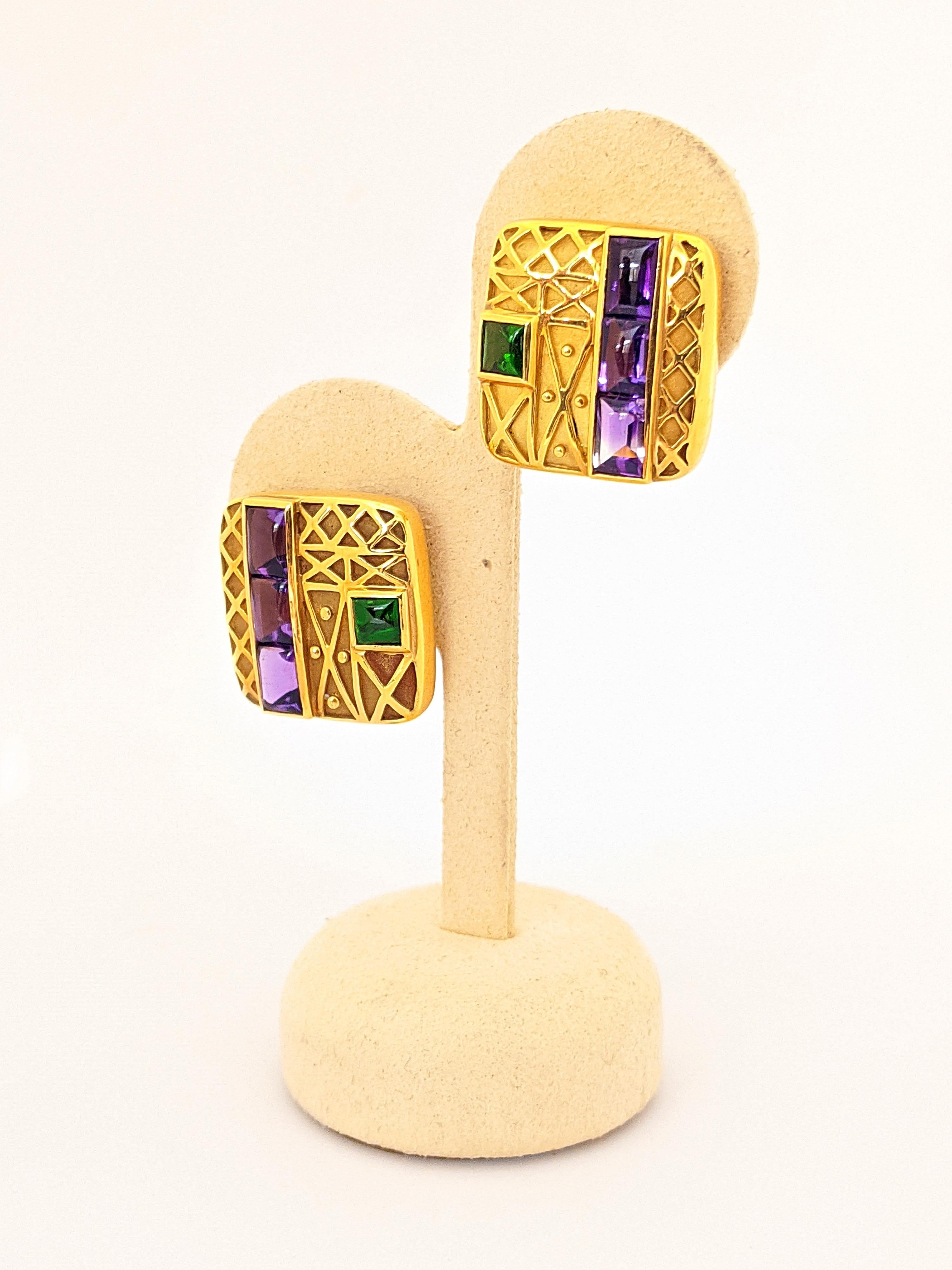 Designed by the Charles Turi for Cellini.  These square earrings are designed in 18 karat yellow gold. They have a matte finish with polished geometric shaped details. Each earring is set with sugarloaf cabachon Amethyst and Green Chrome Diopside.