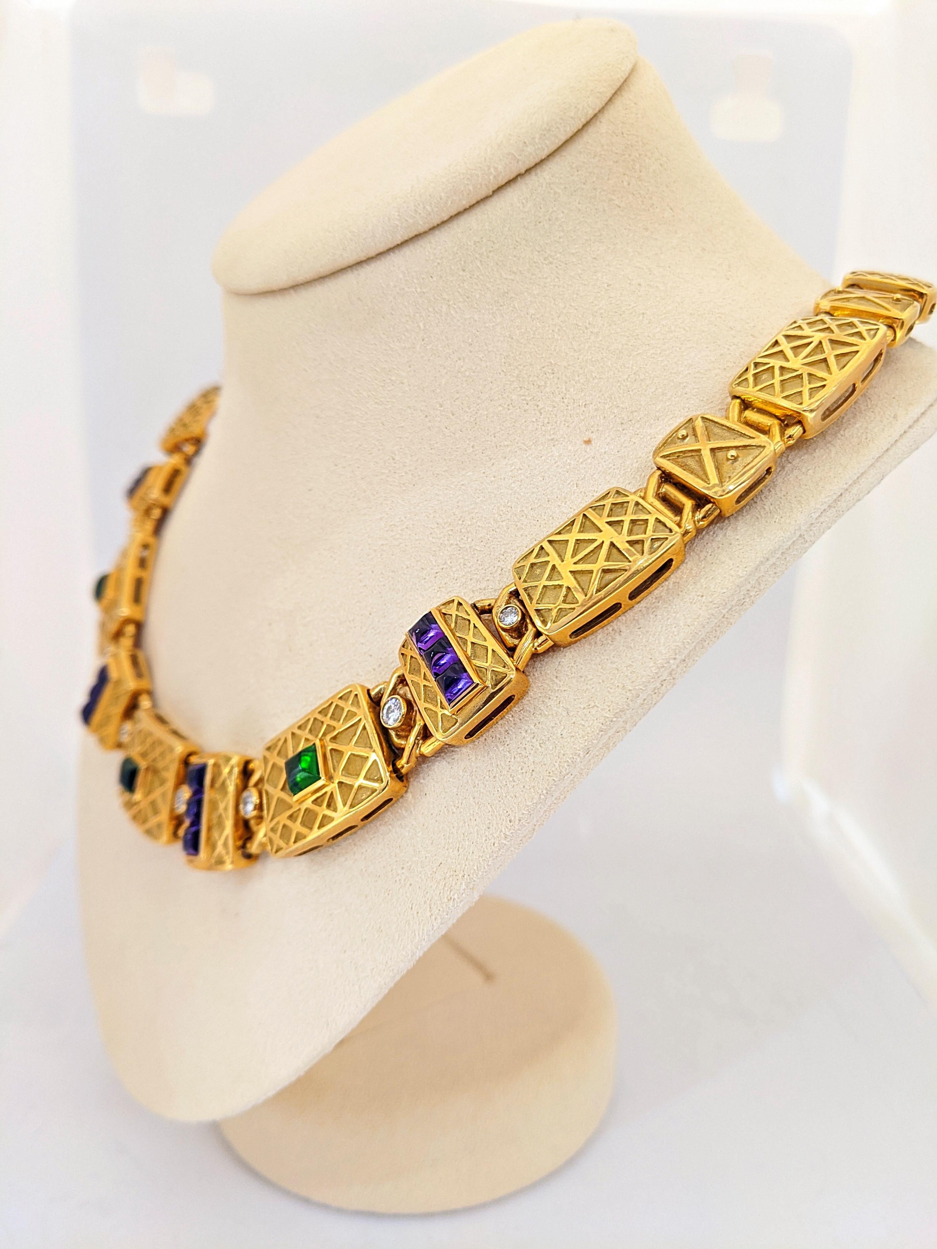 Designed by the Charles Turi Company for Cellini. This 18 karat gold necklace features 24 yellow gold links with a geometric pattern. They alternate between large and small.  The front 7 links are set with sugarloaf cabachon Amethyst and Green