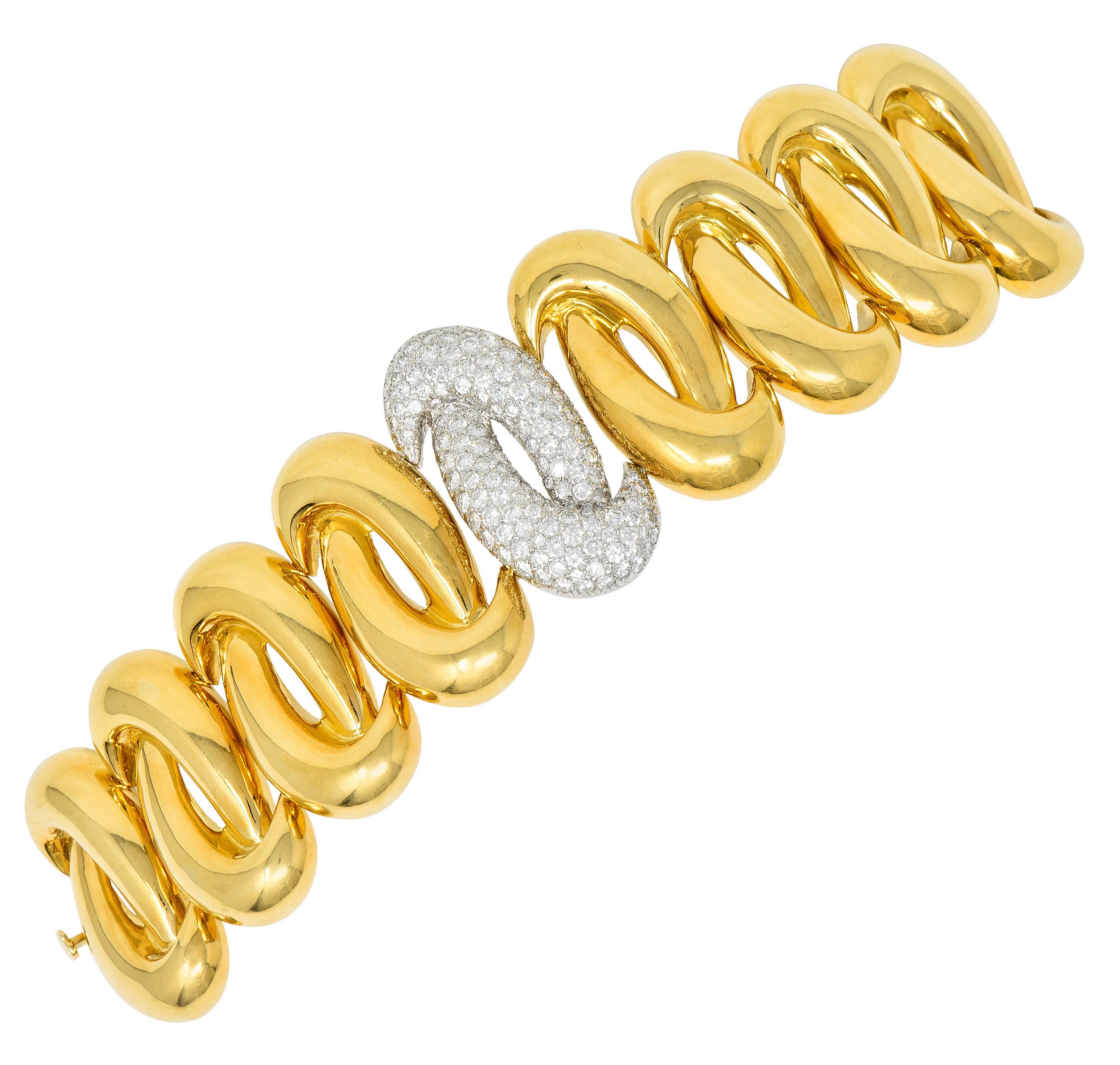 Statement bracelet is comprised of gleaming gold knot motif links

While centering a white gold station pavè set throughout by round brilliant cut diamonds

Weighing in total approximately 7.50 carats with F to G color and VS to SI