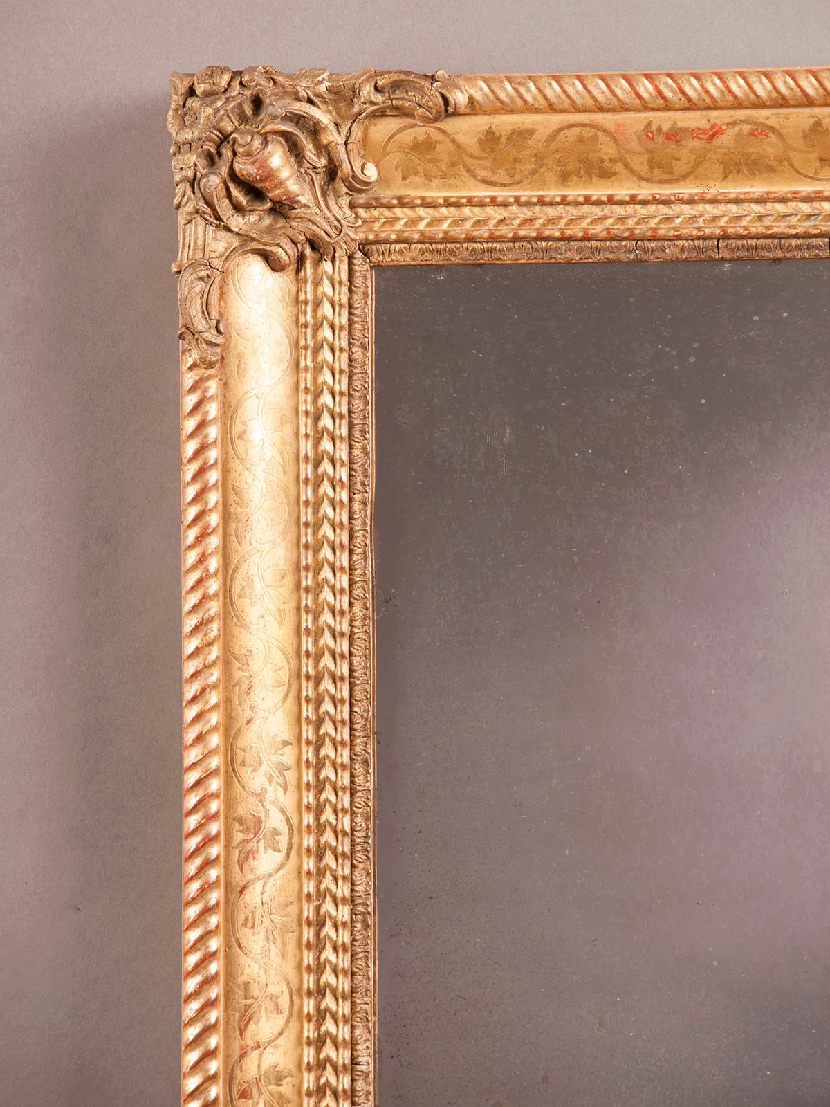 A handsome Charles X antique French gold leaf mirror, circa 1840. Please note that the symmetrical aspect of this mirror frame ensures it may be hung either vertically or horizontally. There is a unique aspect to this frame visible in each of the
