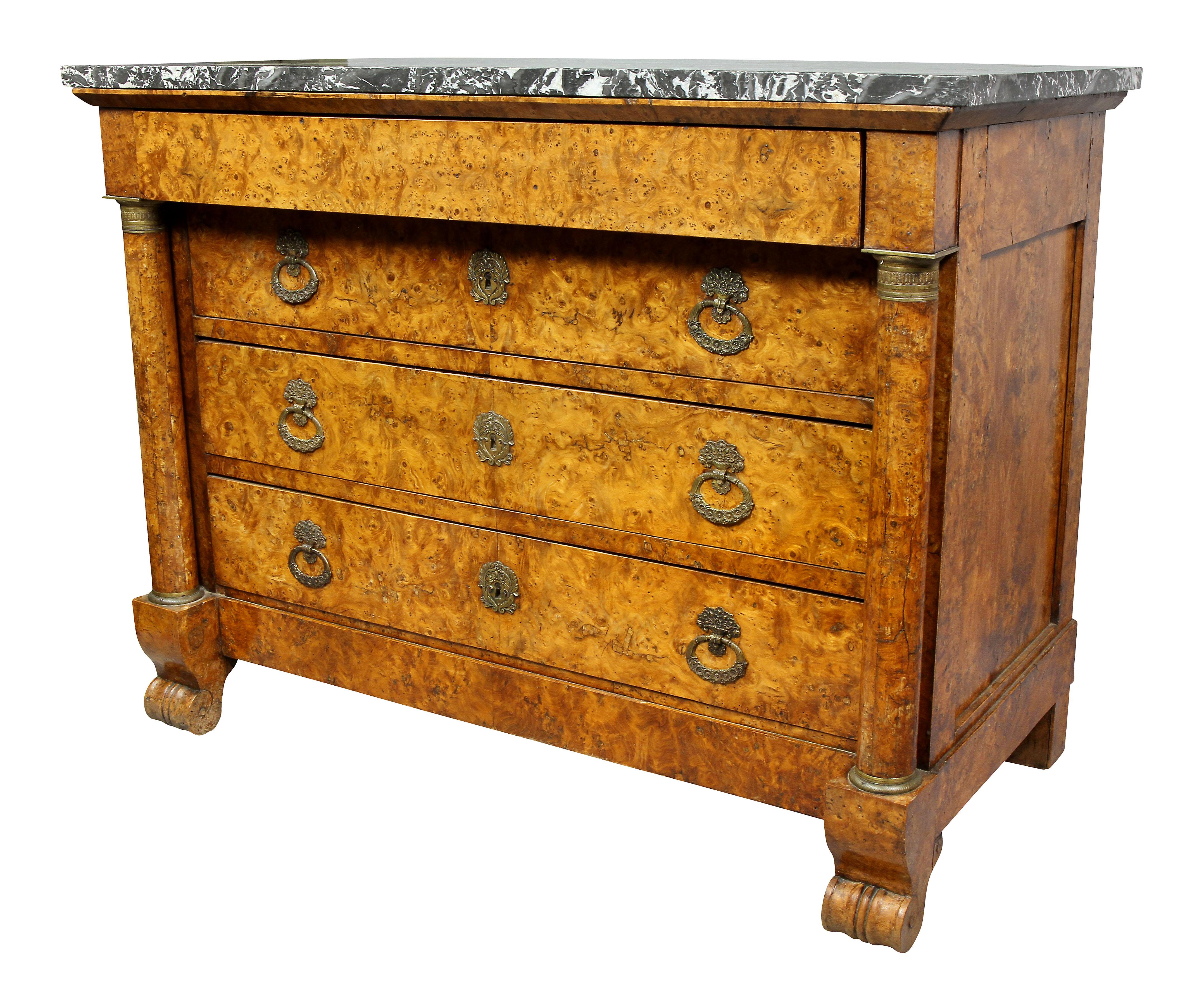 With a rectangular St Anne gray marble top over a frieze drawer over three graduated drawers flanked by columns, scroll feet. Original bronze handles.