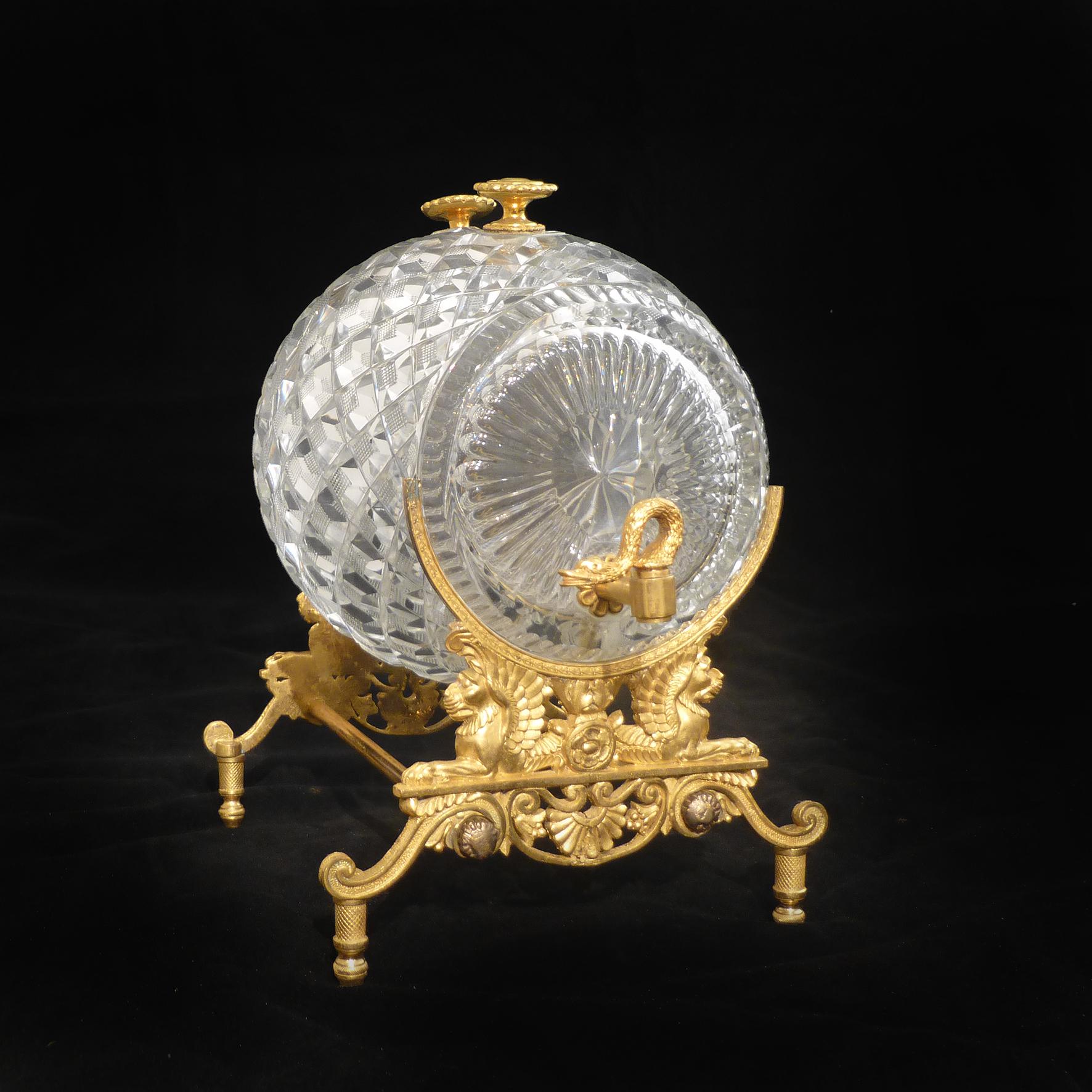 An unusual Charles X crystal and gilt-bronze spirit or perfume dispenser, in the shape of a barrel with swan head taps,

French, circa 1830.