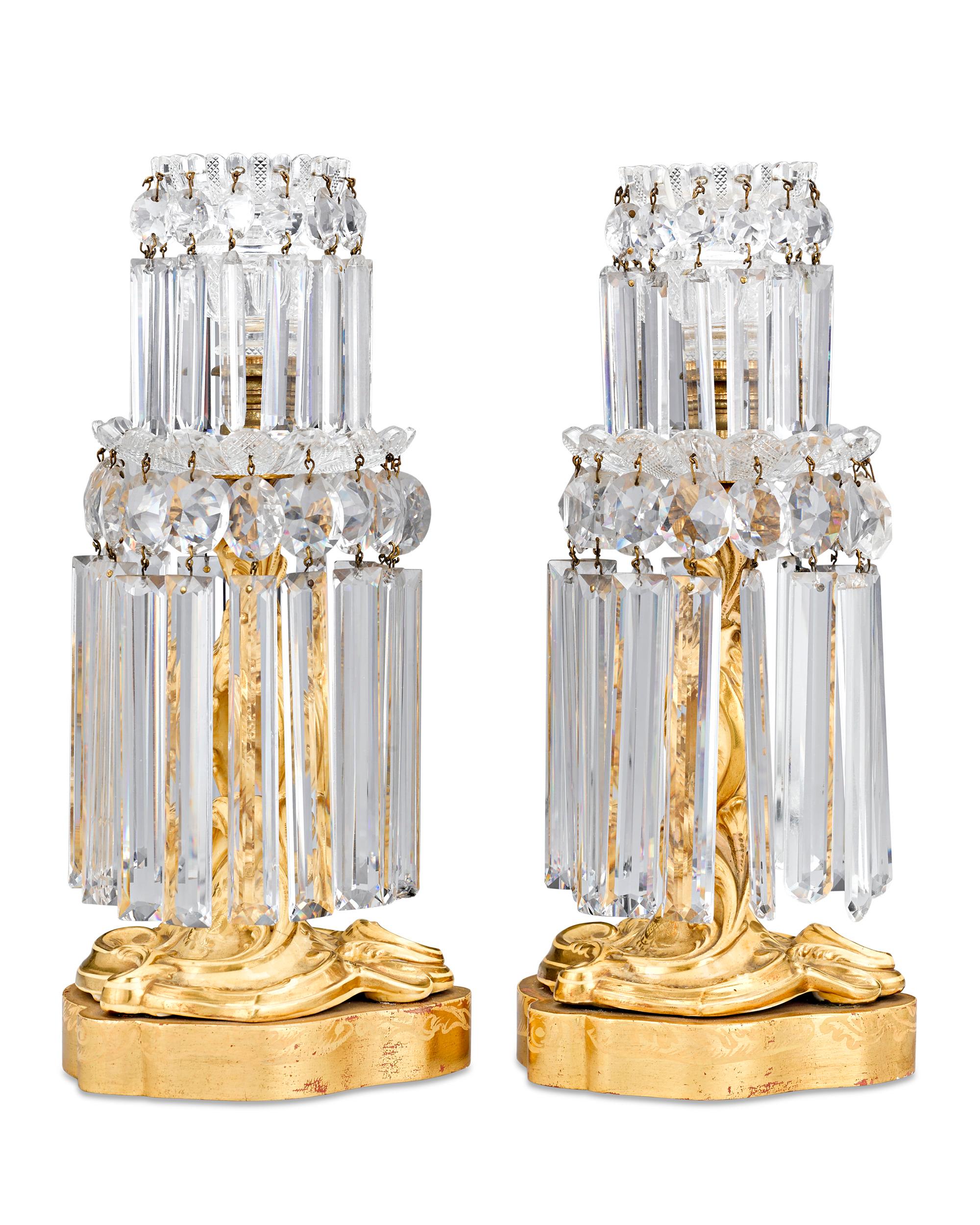 This rare pair of French crystal lusters dates to the Charles X period and embodies the extraordinary artistry achieved during this brief era. The ornately cut prisms beautifully capture the light, creating a gorgeous effect as they cast a warm glow