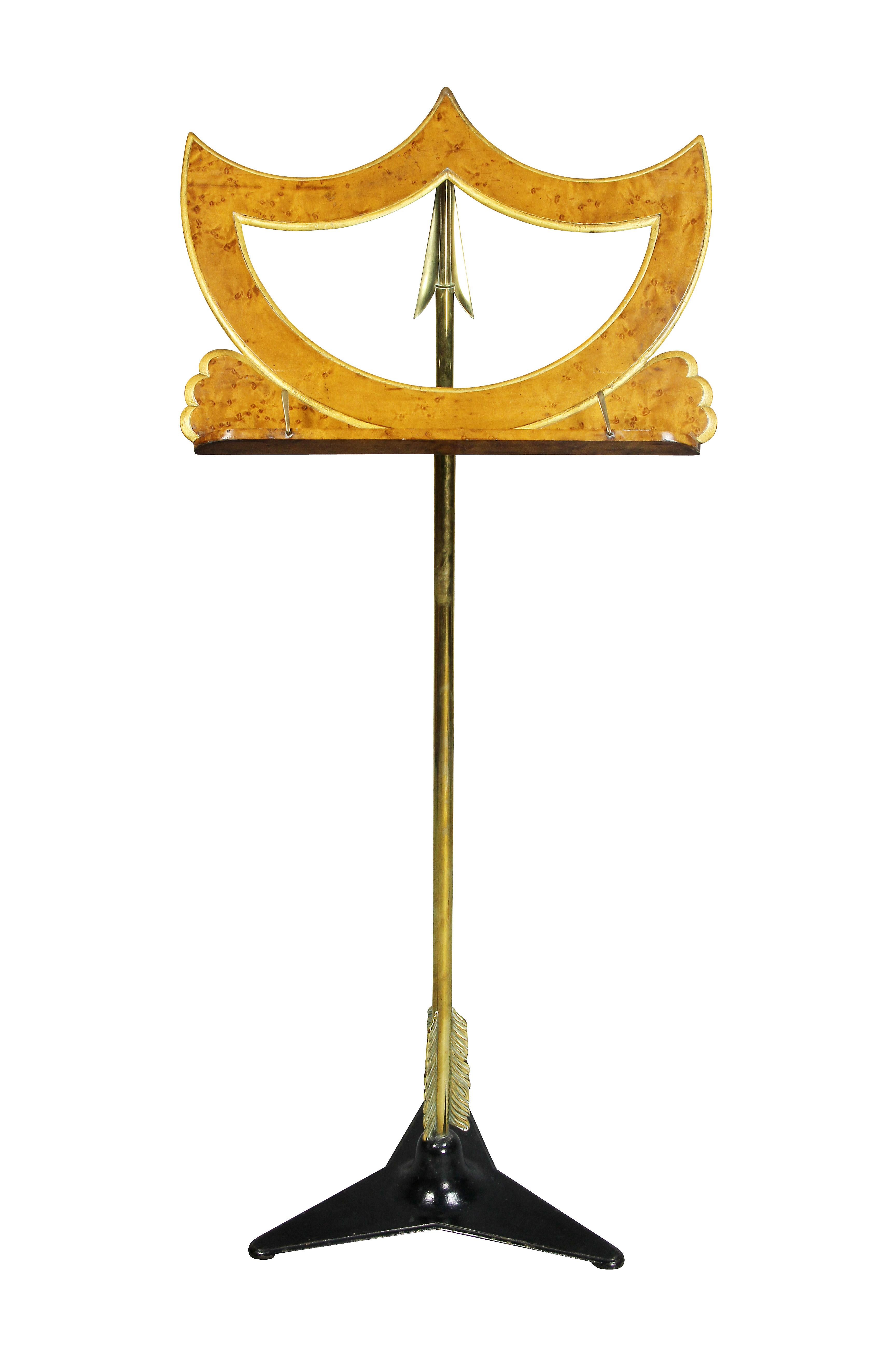Shield shaped top and adjustable brass arrow form support, triangular black painted iron.