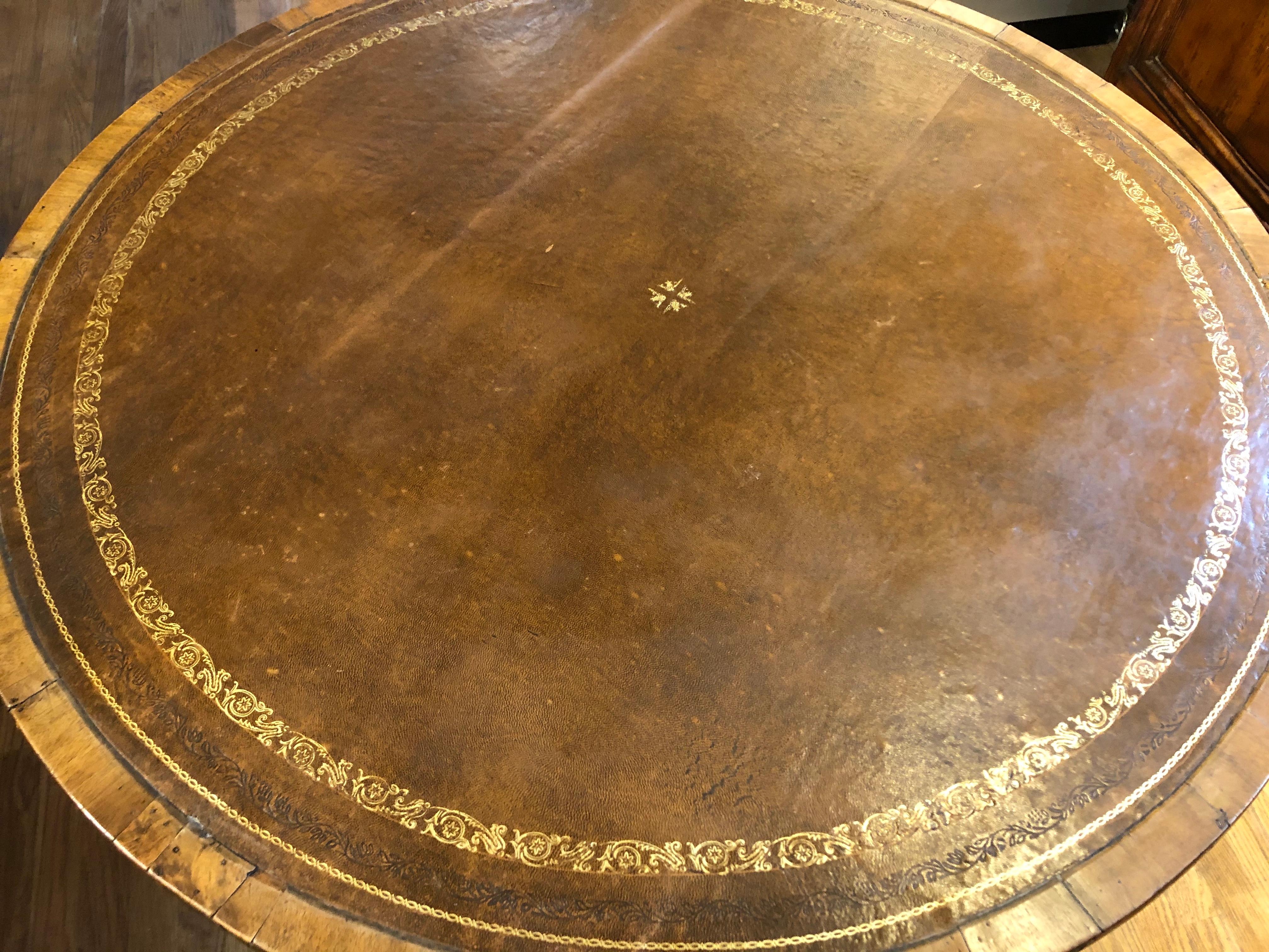 Unusually fine Charles X French Provincial tilt-top wine table made predominantly of richly patinated walnut and oak with cross-banded circular top covered in brown tooled and gilded leather. Shows little to no signs of age. Beautiful