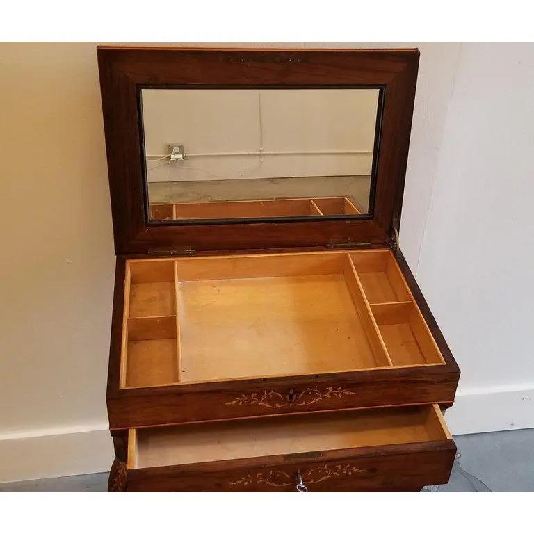 A fine antique rosewood vanity with satinwood marquetry. Mirrored and fitted interior. Retaining original castors, circa 1825.