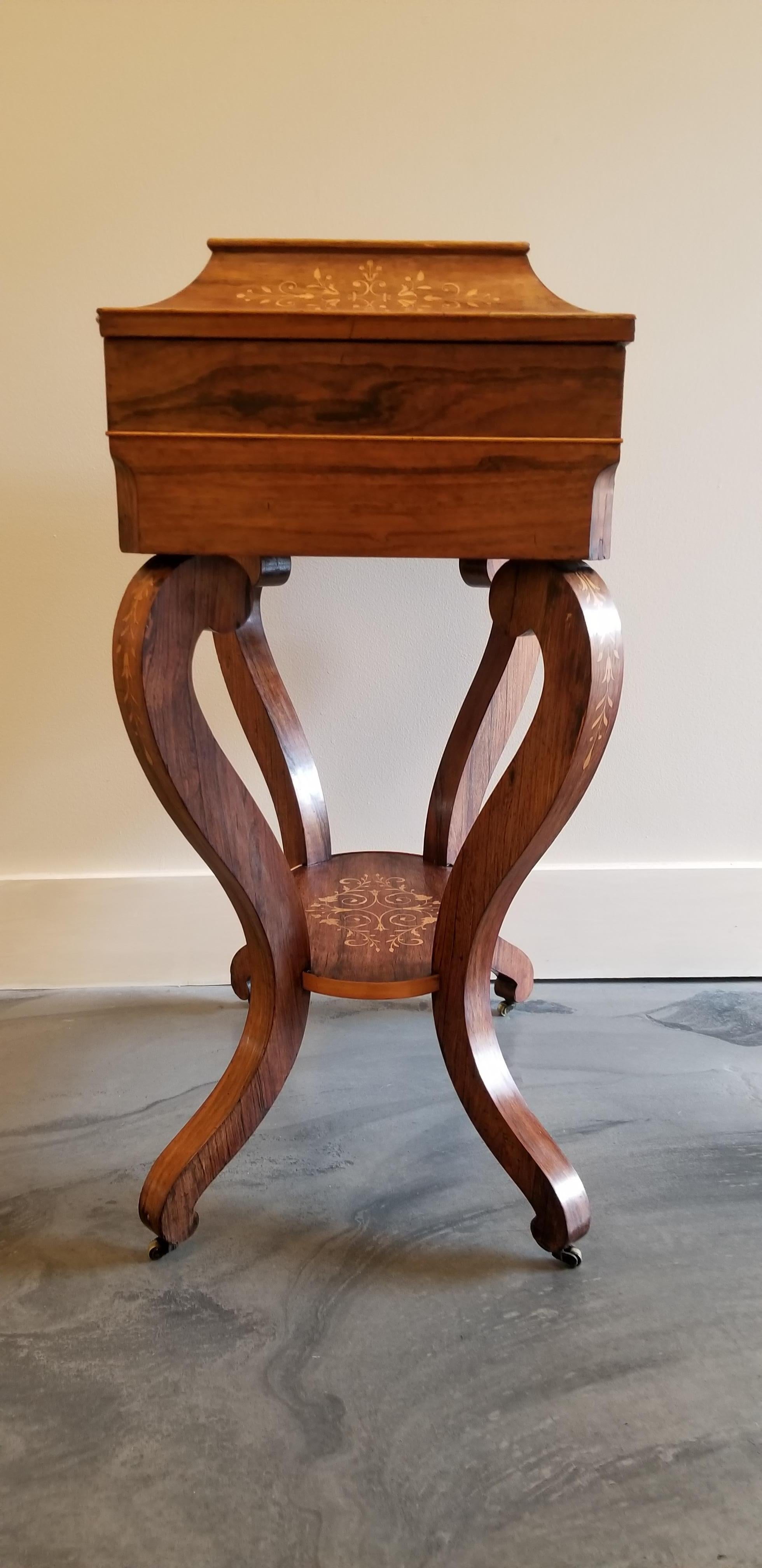 A fine antique rosewood vanity with satinwood marquetry. Mirrored and fitted interior. Retaining original castors, circa 1825.