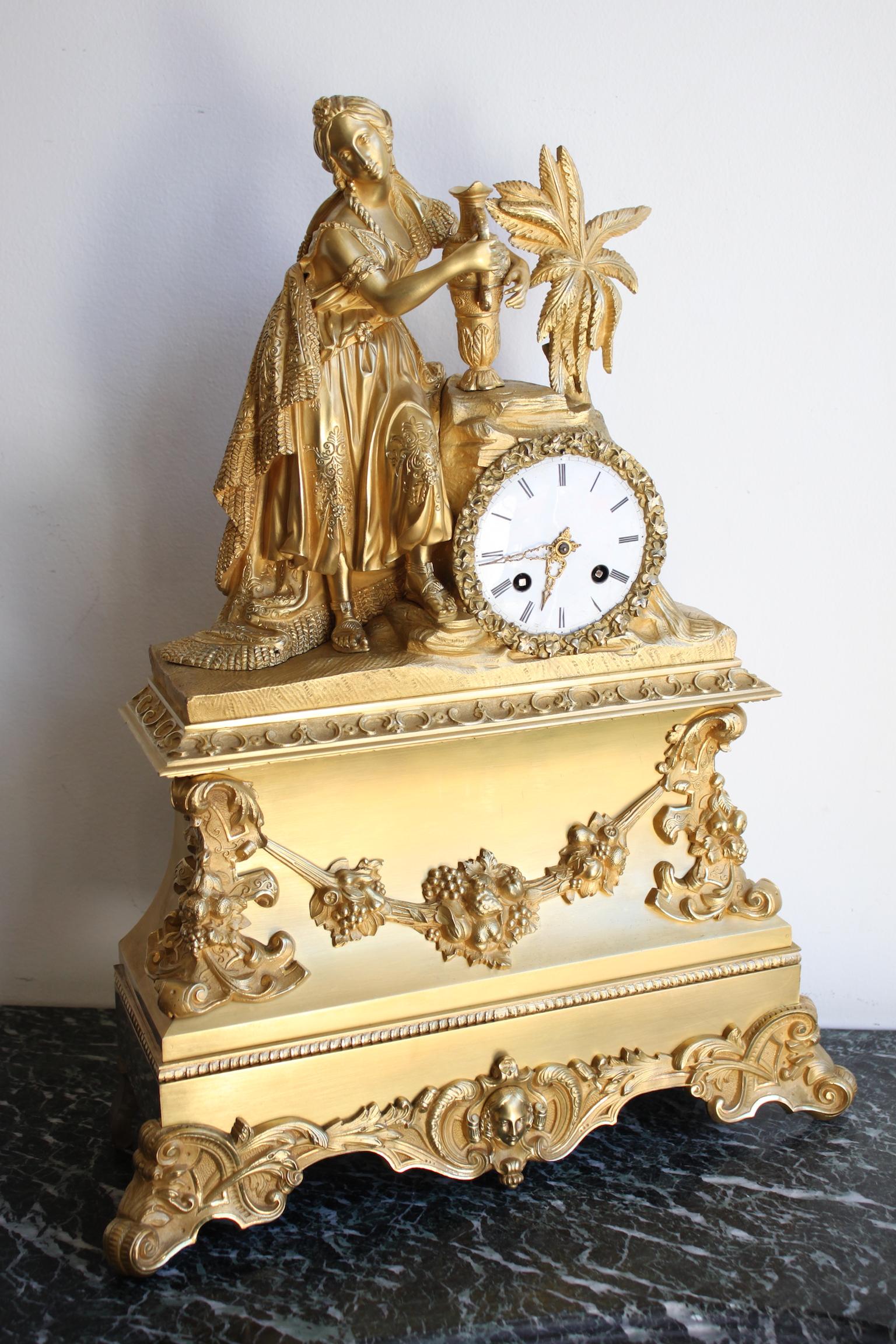 Charles X Oriental clock representing a woman with a jug, Charles X. In working order.
Dimensions: width 37cm, depth 12cm, height 48.5cm.