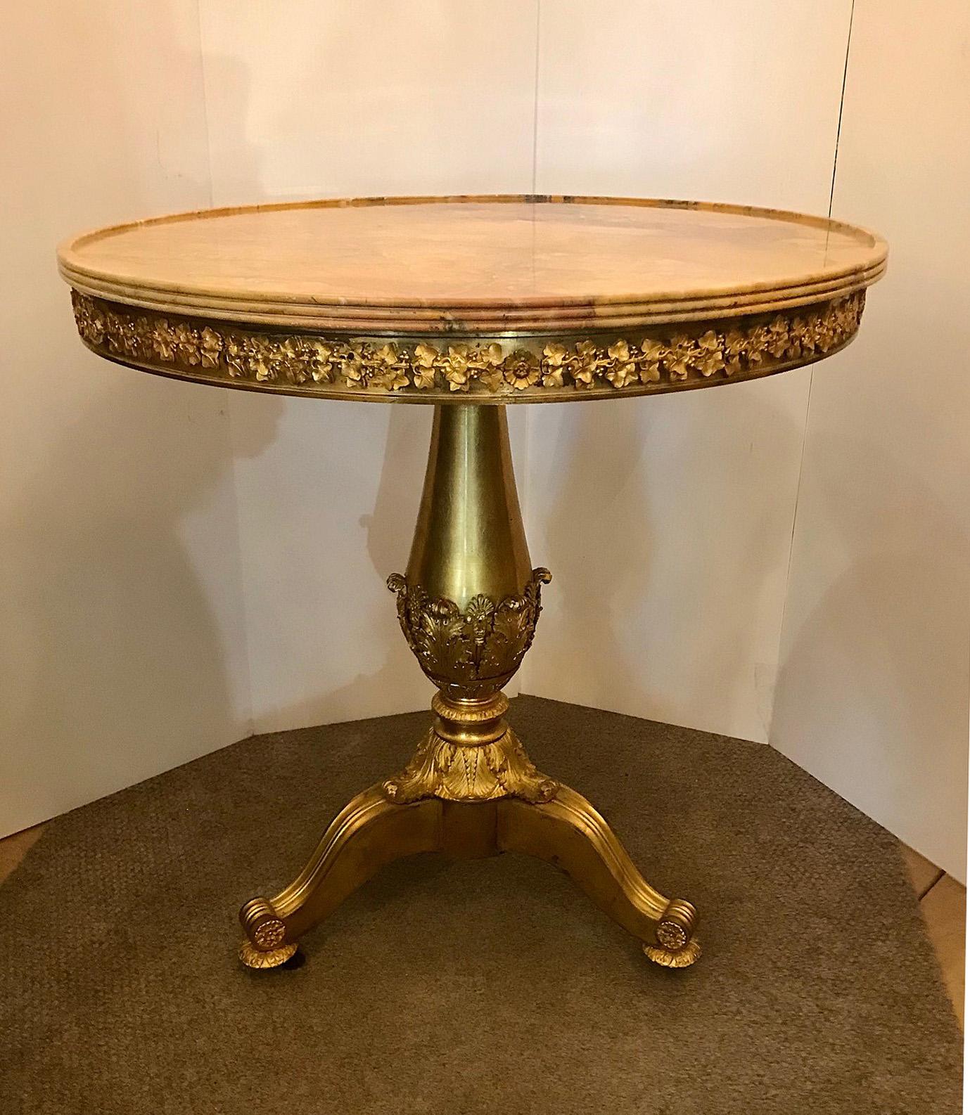 An important Restauration period ormolu Gueridon, c. 1820, Attributed to Pierre-Philippe Thomire (1751-1843).   
With a round Siena marble molded edge top, the frieze with a plain molded border and applied with a repeat of trailing vine and rosette