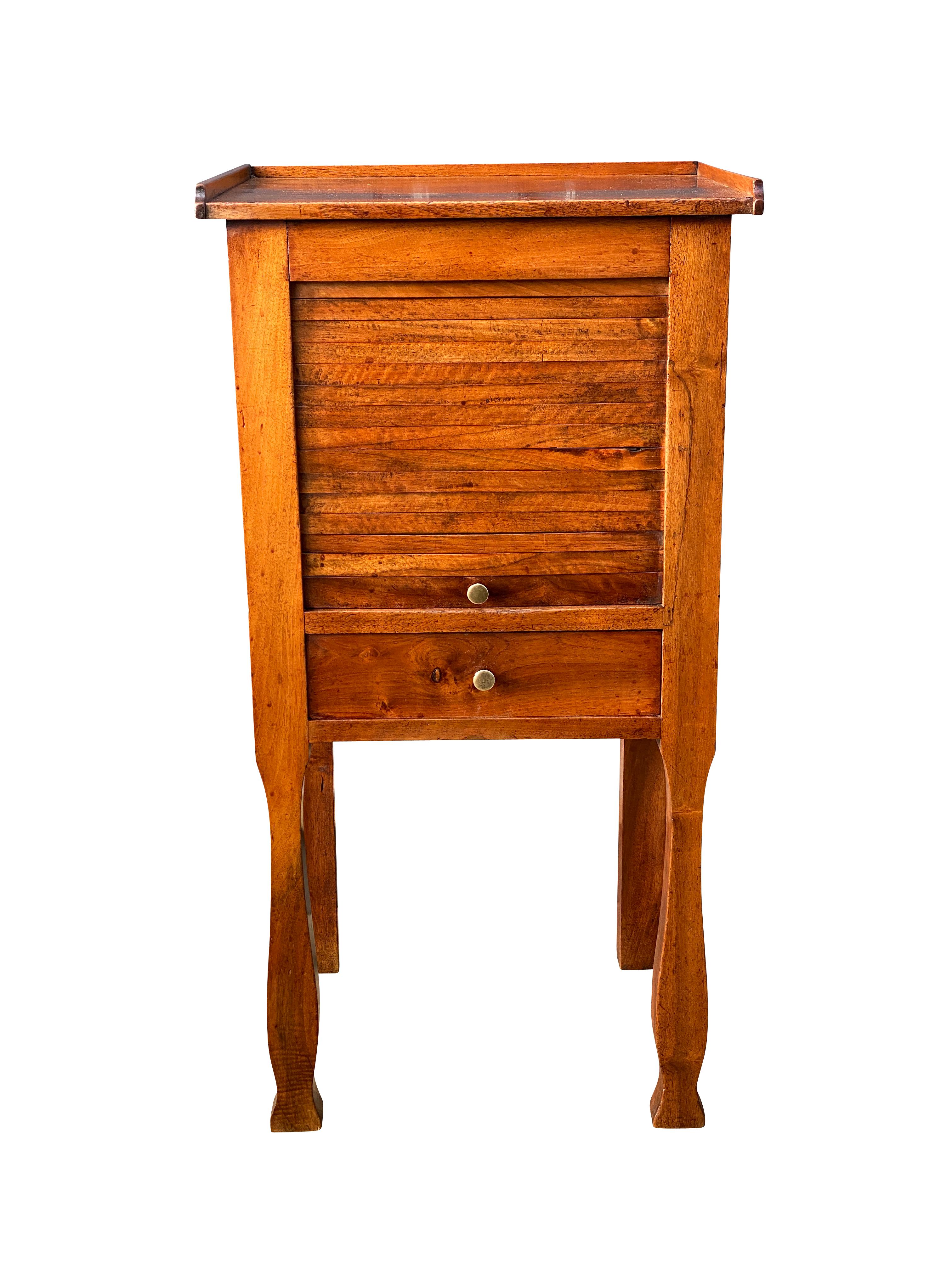 With rectangular three quarter gallery top over a tambour door and a drawer raised on shaped straight legs.