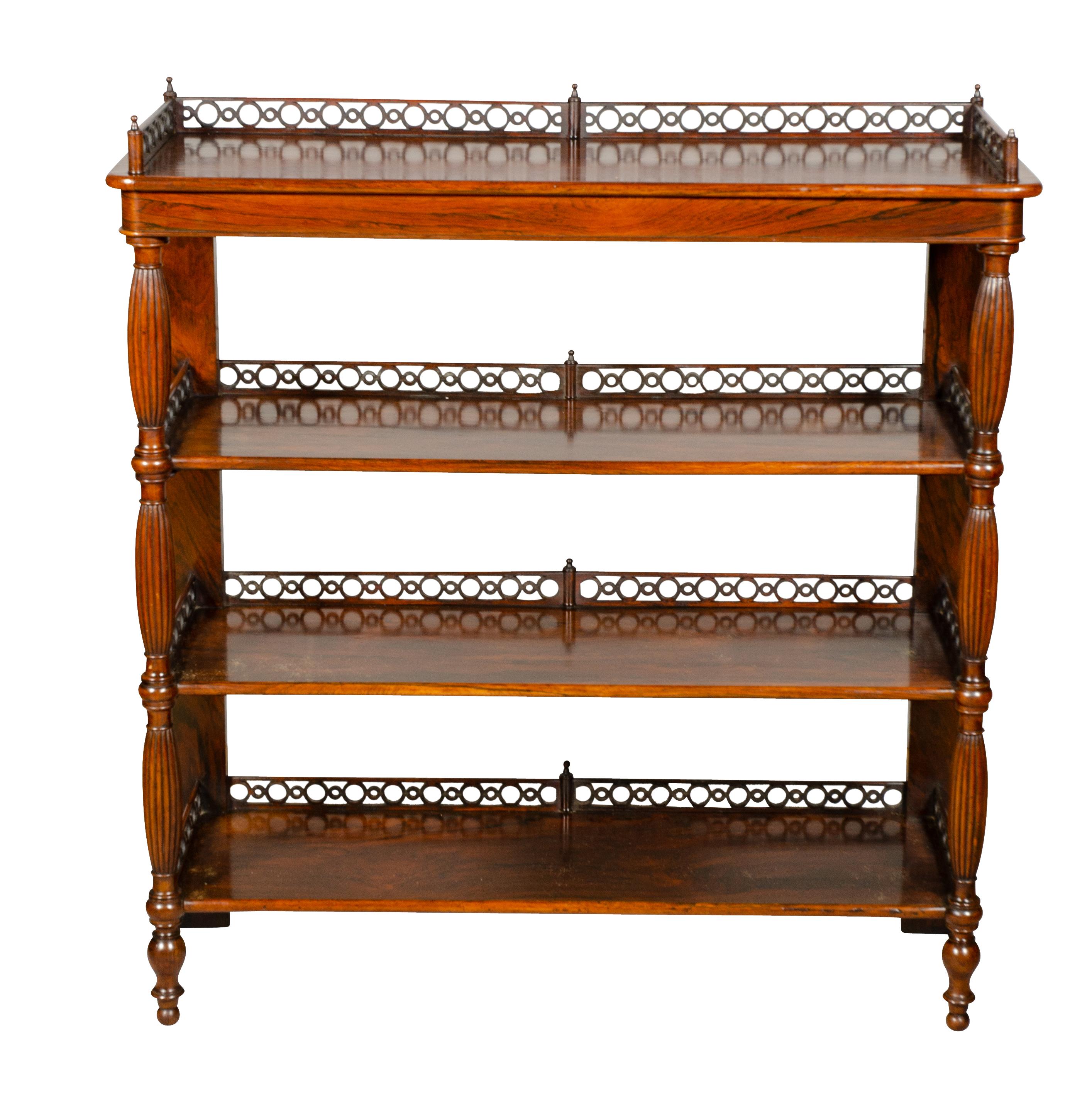 With rectangular top with intricate fretwork 3/4 gallery with alternating larger and smaller rings over three lower shelves all with 3/4 gallery all supported on reeded legs ending on toupie feet. Great condition and well made.