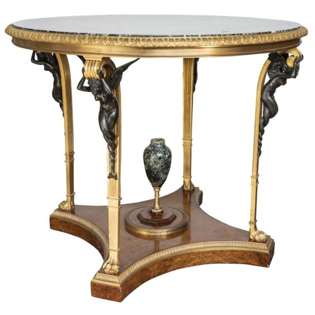 Charles X style bronze mounted Verde antique marble and aboyna wood large gueridon, circa 1900, the base stamped CF and MCF, the rim with a leaf cast frieze, with fluted supports cast in bronze and headed by nautical winged female sphinxes, raised